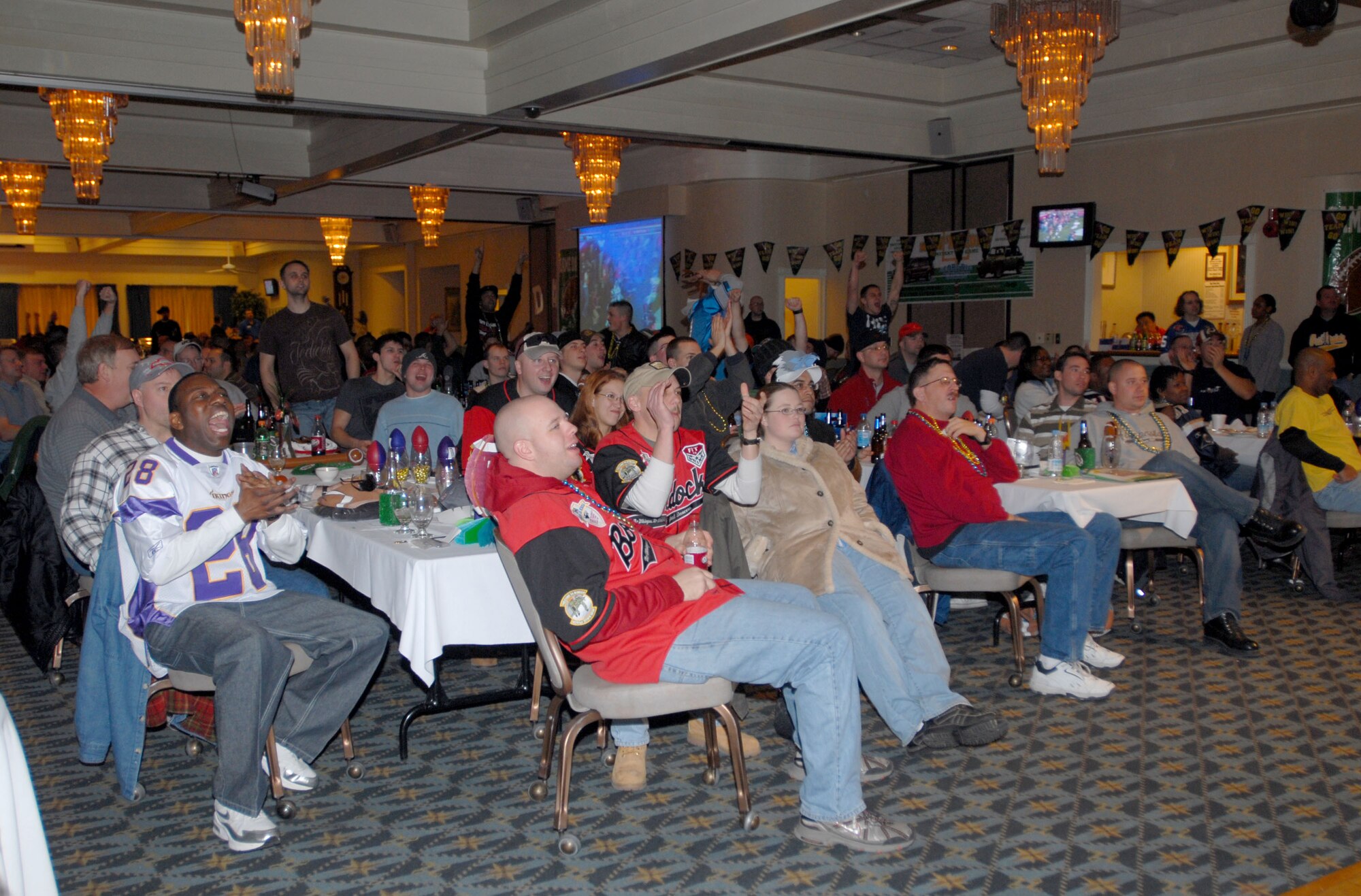 KUNSAN AIR BASE, South Korea -- Members of the 8th Fighter Wing gather at the Loring Club for the Super Bowl XLII Bash sponsored by the 8th Services Squadron here Feb. 4.  The 8th Services Squadron sponsors numerous events through out the year to boost Airmen morale and espirit de corp.  (U.S. Air Force photo/Staff Sgt. Darcie Ibidapo)