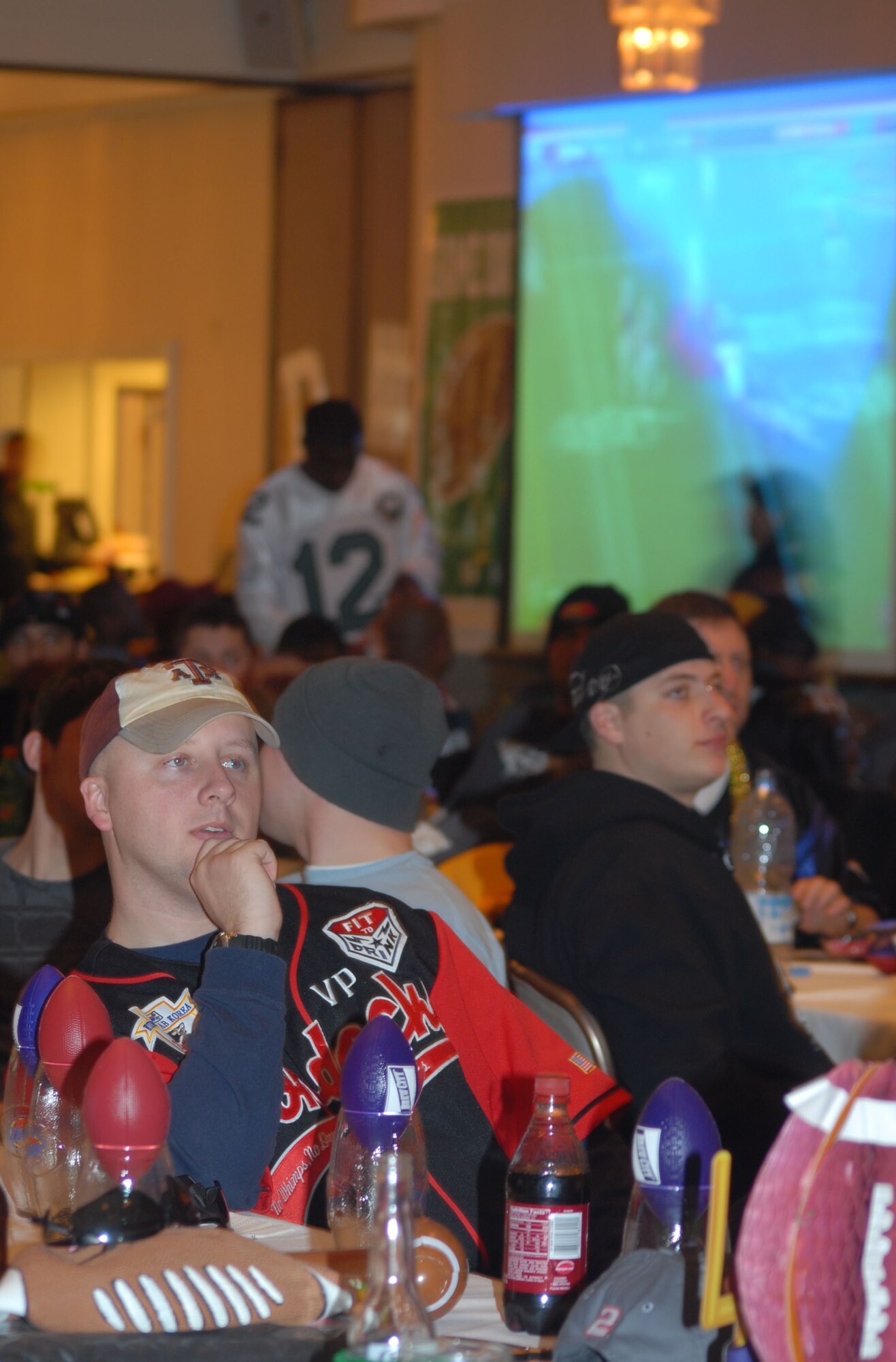 KUNSAN AIR BASE, South Korea -- Specialist Roger Bart, from the 35th Brigade, C Battery, 1st of the 44th watches the game during the Super Bowl XLII Bash sponsored by the 8th Services Squadron here Feb. 4.  The 8th Services Squadron sponsors numerous events through out the year to boost Airmen morale and espirit de corp.  (U.S. Air Force photo/Staff Sgt. Darcie Ibidapo) 