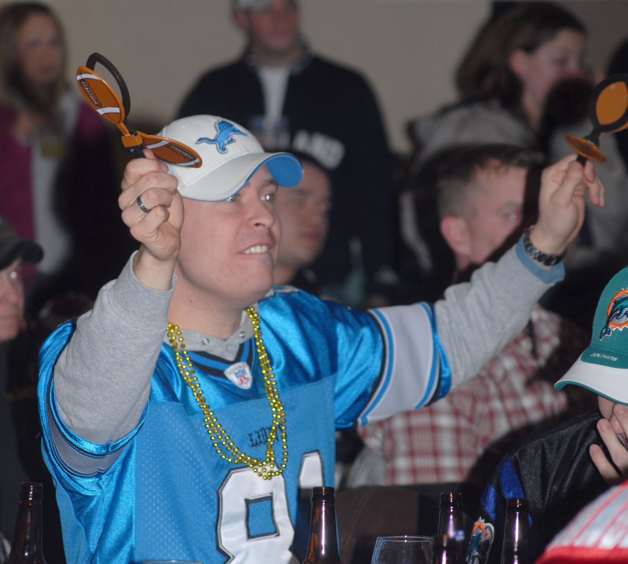 KUNSAN AIR BASE, South Korea -- Senior Airman Steve Schroeder, from the 8th Maintenance Squadron shakes his football clappers during the Super Bowl XLII Bash sponsored by the 8th Services Squadron here Feb. 4.  The 8th Services Squadron sponsors numerous events through out the year to boost Airmen morale and espirit de corp.  (U.S. Air Force photo/Staff Sgt. Darcie Ibidapo)
