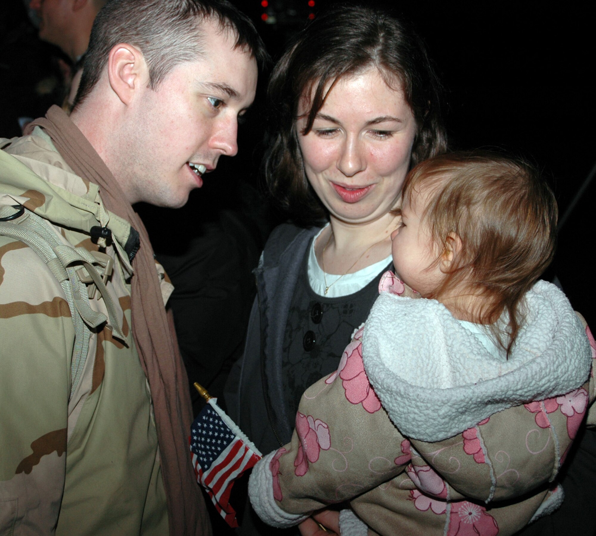 NIAGARA FALLS AIR RESERVE STATION, N.Y. -- Staff Sgt. John Glyshaw, 914th Security Forces Squadron, greets his wife and daughter on the flight line here after stepping off the C-130 aircraft that brought him home Jan. 29 from deployment to Iraq. (U.S. Air Force Photo / Airman Andrew Caya)