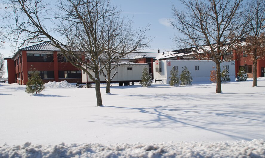 Construction trailers are parked next to the former headquarters building of the 932nd Airlift Wing which saw the first snowfall of 2008.  The building is under renovation until fall 2008 and elements of the unit are spread out in other facilities around the base.