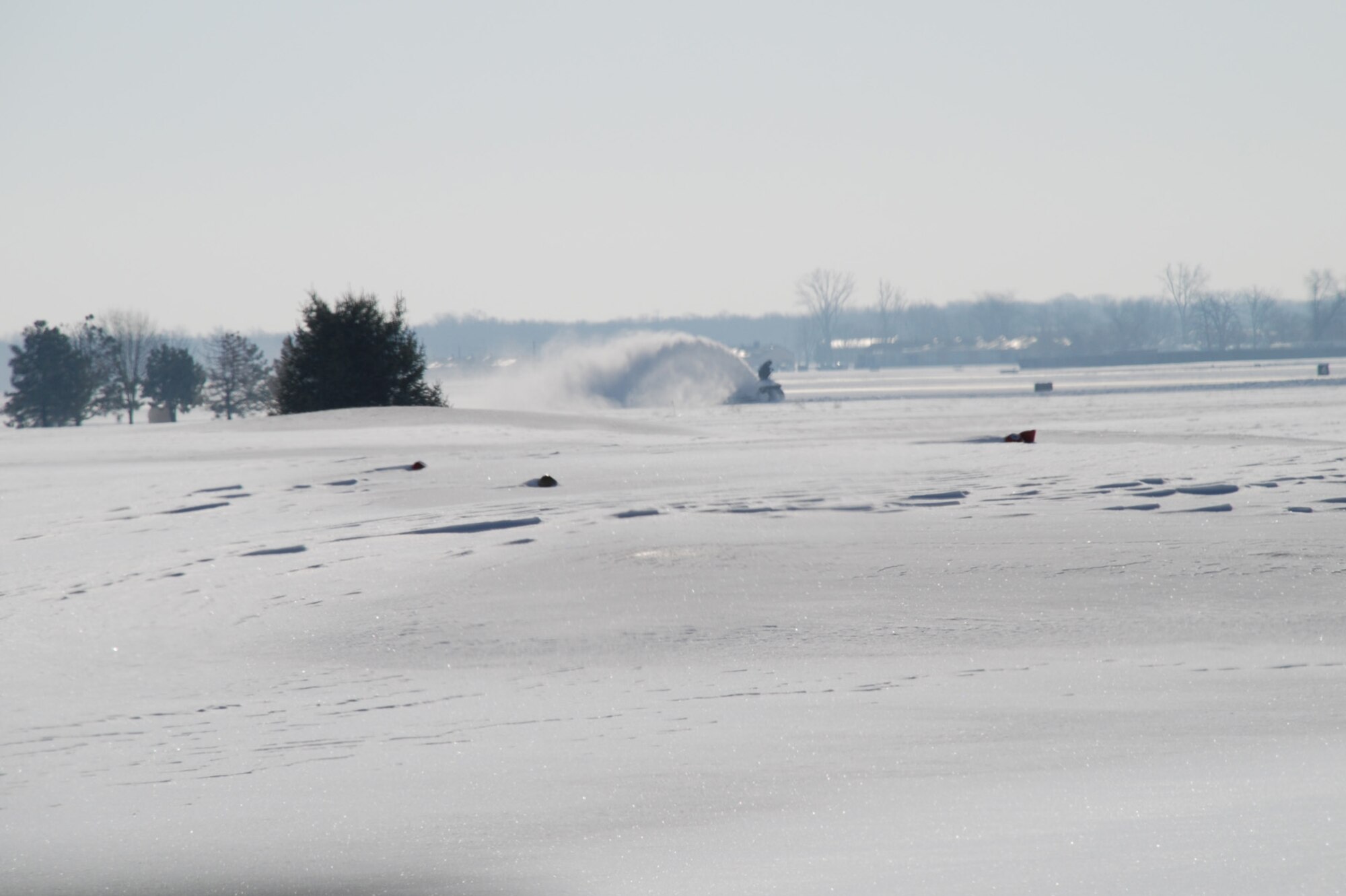 A snow removal machine clears the area where the 932nd Airlift Wing operates its C-40C and C-9C planes.  The first snowfall of 2008 happened January 31-February 1.