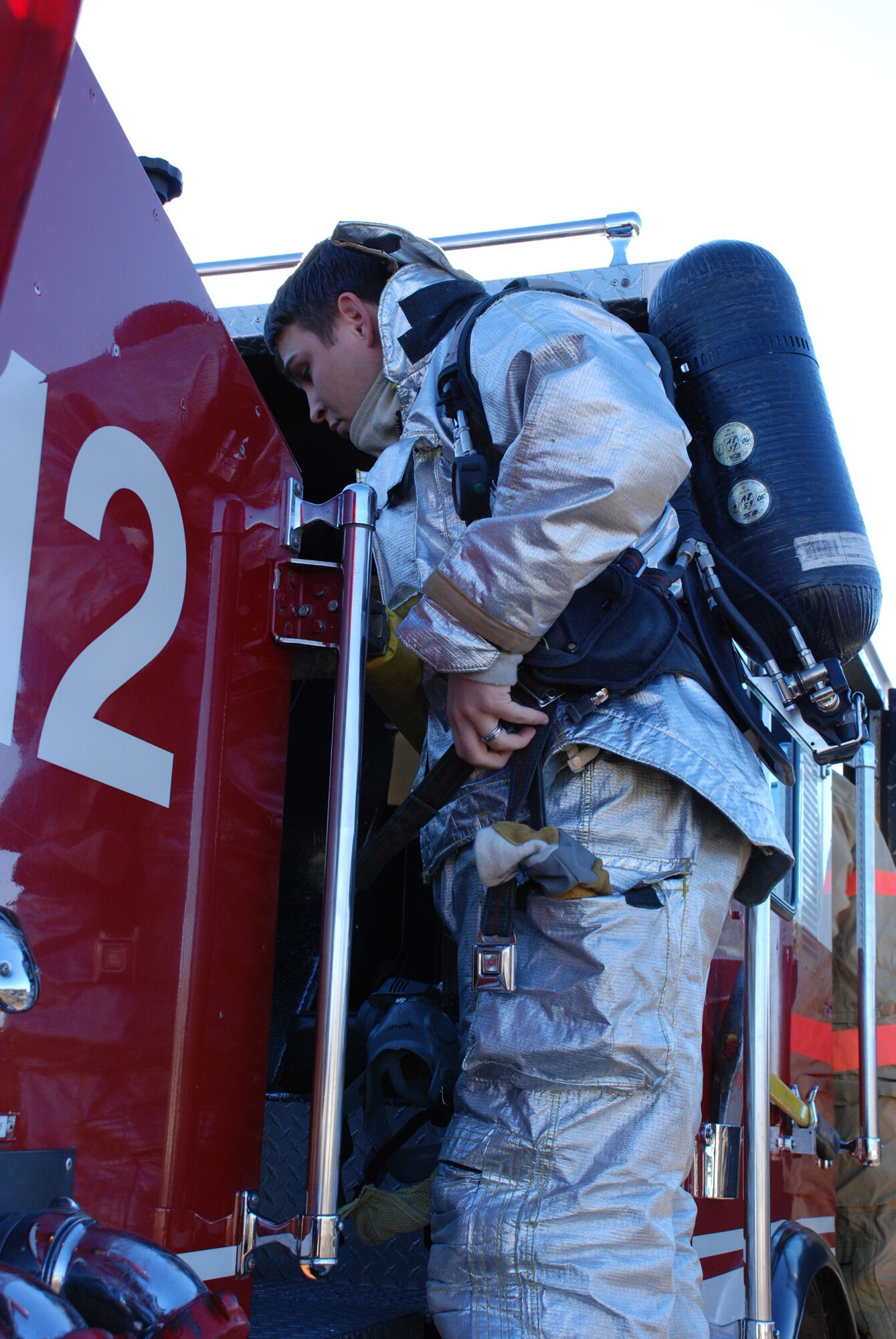 932nd Airlift Wing firefighters constantly practice to stay ready. Here, a firefighter gets his oxygen tank and suit on as he prepares to enter simulated smoke; this is designed to teach firefighters to understand how their field of vision and awareness of surroundings is affected by thick smoke. 932nd Airlift Wing firefighters constantly practice to stay ready.  Interested in the Air Force Reserve Command firefighting program? Call 1-800-257-1212 for more information on openings and training required. Photo/Capt. Stan Paregien