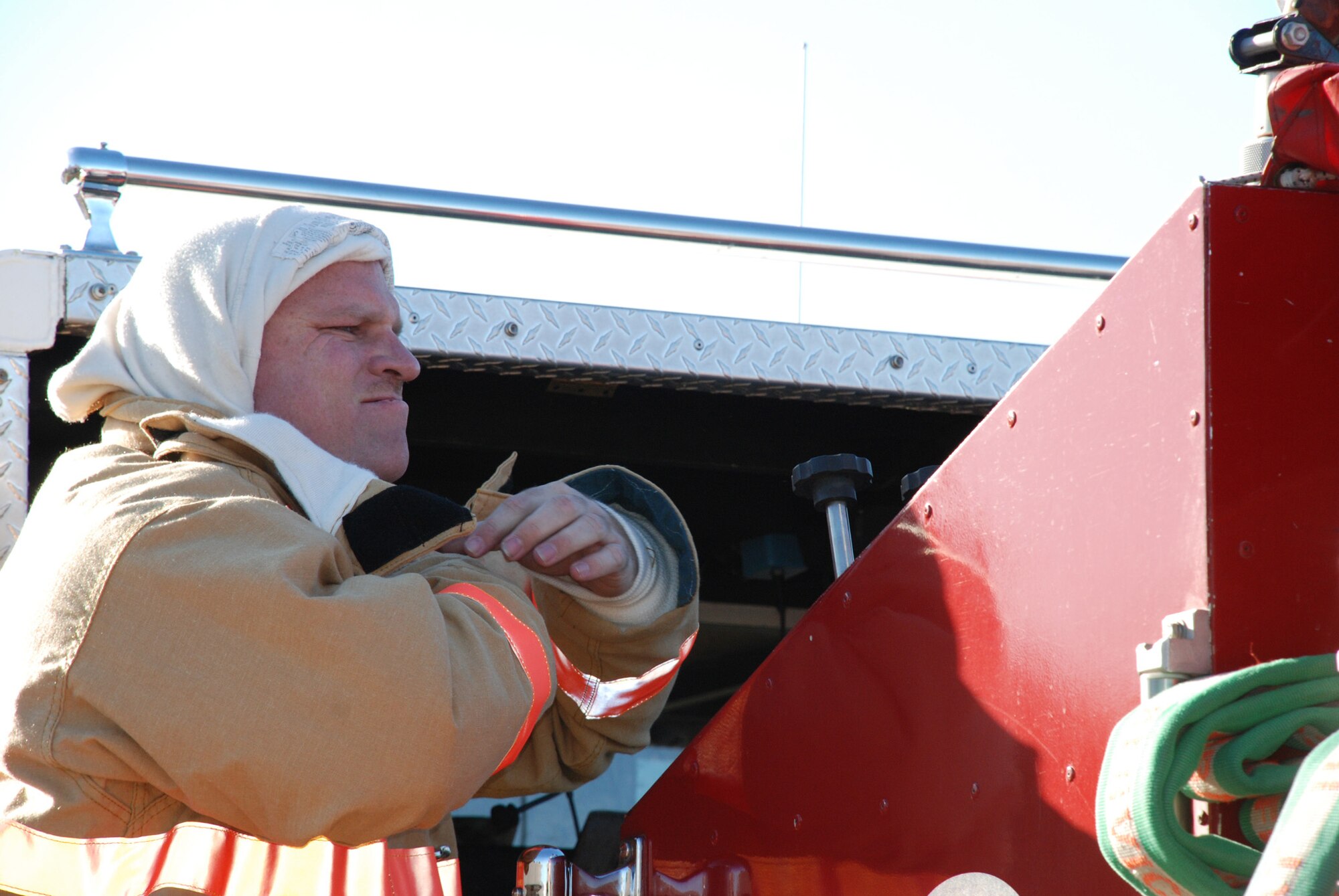 932nd Airlift Wing firefighters constantly practice to stay ready. Here, a firefighter gets his fire retardant suit on as he prepares to enter simulated smoke during a recent drill; this is designed to teach firefighters to understand how their field of vision and awareness of surroundings is affected by thick smoke. Heat can be a problem especially when wearing the heavy gear.  932nd Airlift Wing firefighters constantly practice to stay ready.  Interested in the Air Force Reserve Command firefighting program? Call 1-800-257-1212 for more information on openings and training required. Photo/Capt. Stan Paregien 