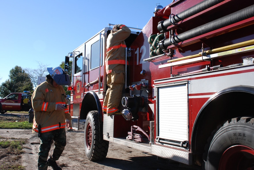 932nd Airlift Wing firefighters constantly practice to stay ready. Here, a firefighter listens to instructions over his radio.  He also gets his fire retardant suit on as he prepares to enter simulated smoke during a recent drill; this is designed to teach firefighters to understand how their field of vision and awareness of surroundings is affected by thick smoke. Heat can be a problem especially when wearing the heavy gear.  932nd Airlift Wing firefighters constantly practice to stay ready.  Interested in the Air Force Reserve Command firefighting program? Call 1-800-257-1212 for more information on openings and training required. Photo/Capt. Stan Paregien 