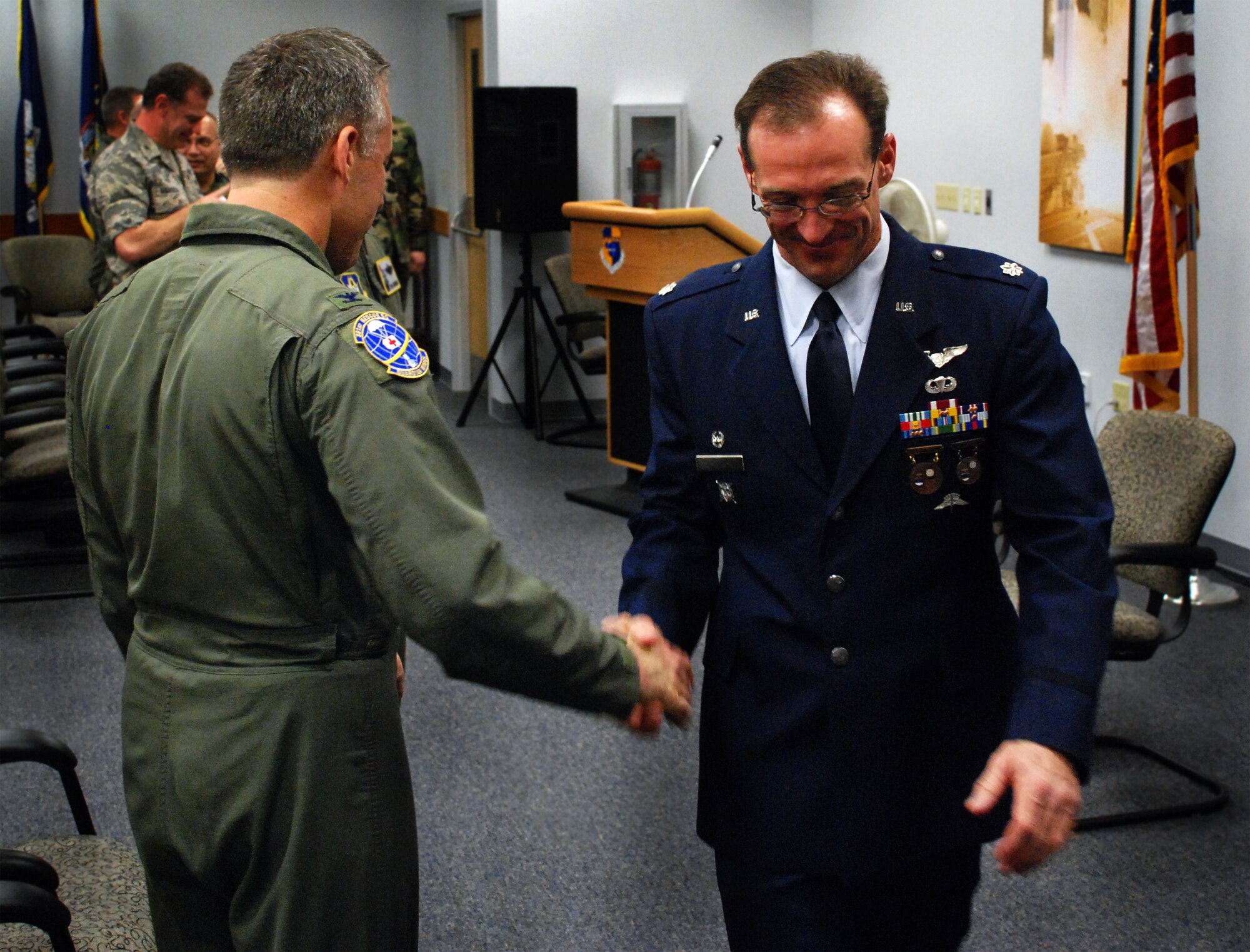 PATRICK AIR FORCE BASE, Fla. -- Lt. Col. Coy Speer receives a farewell handshake from 920th Rescue Wing commander Col. Steven Kirkpatrick after passing command of the wing's pararescue squadron during a ceremony held at the professional development center here today. Lt. Col. Joel Kinnunen, a former rescue-helicopter pilot, succeeded Colonel Speer, who is retiring after 20 years of service to teach science at a high school in Arizona. Air Force pararescue men provide combat search and rescue support for special operations units and pilots shot down behind enemy lines, search and rescue service for civilian mariners, humanitarian relief during natural disasters and provide emergency medical support for every NASA shuttle and rocket launch. (U.S. Air Force photo/Staff Sgt. Paul Flipse)
