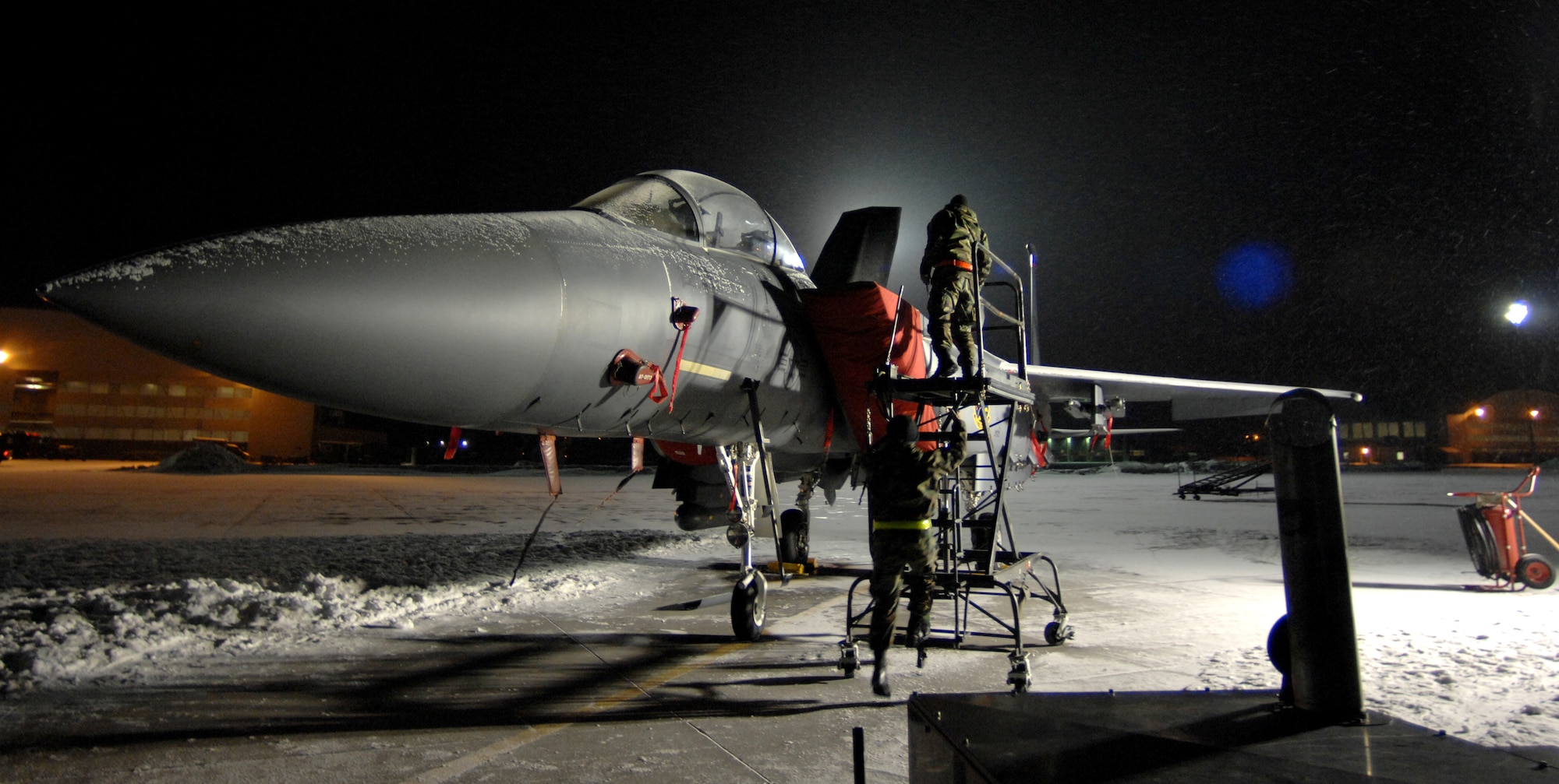 MOUNTAIN HOME AIR FORCE BASE, Idaho-- Senior Airman Michael Bickel and Senior Airman Joseph Harris, 366th Equipment Maintenance Squadron, changes an up light on an F-15E Strike Eagle during phase I of Sharpshooter 08-03 Operation Readiness Exercise here Feb. 2. Units across the base are participating in the exercise to prepare personnel and equipment for the upcoming March 2008 Operational Readiness Inspection. (U.S. Air Force photo/ Airman 1st Class Stephany Miller)