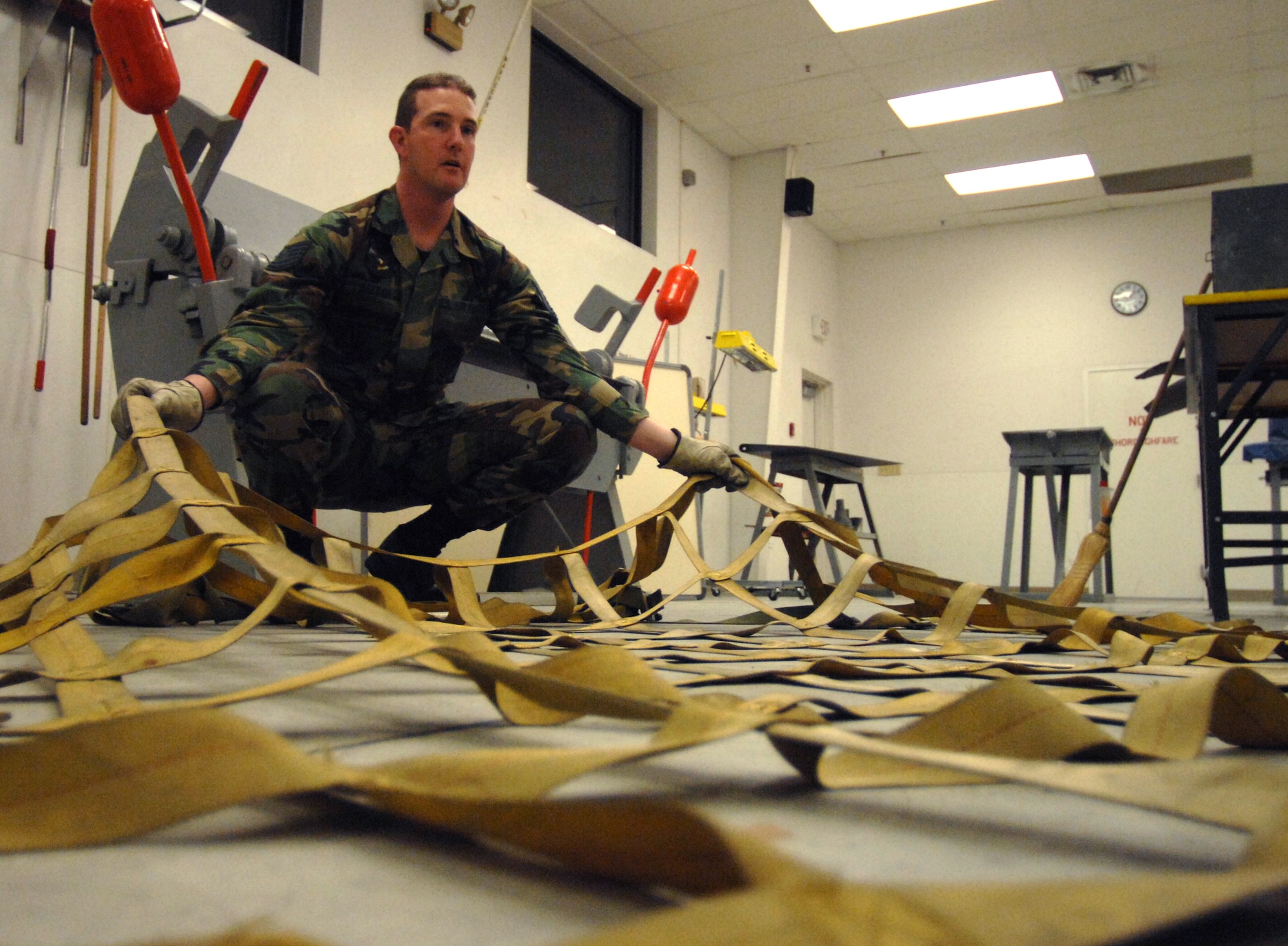 MOUNTAIN HOME AIR FORCE BASE, Idaho-- Technical Sgt. John Deegan, 366th Equipment Maintenance Squadron, prepares the cargo net to put on a pallet during Phase I of Sharpshooter 08-03 Operation Readiness Exercise here Feb. 2. Units across the base are participating in the exercise to prepare personnel and equipment for the upcoming March 2008 Operational Readiness Inspection. (U.S. Air Force photo/ Airman 1st Class Stephany Miller)