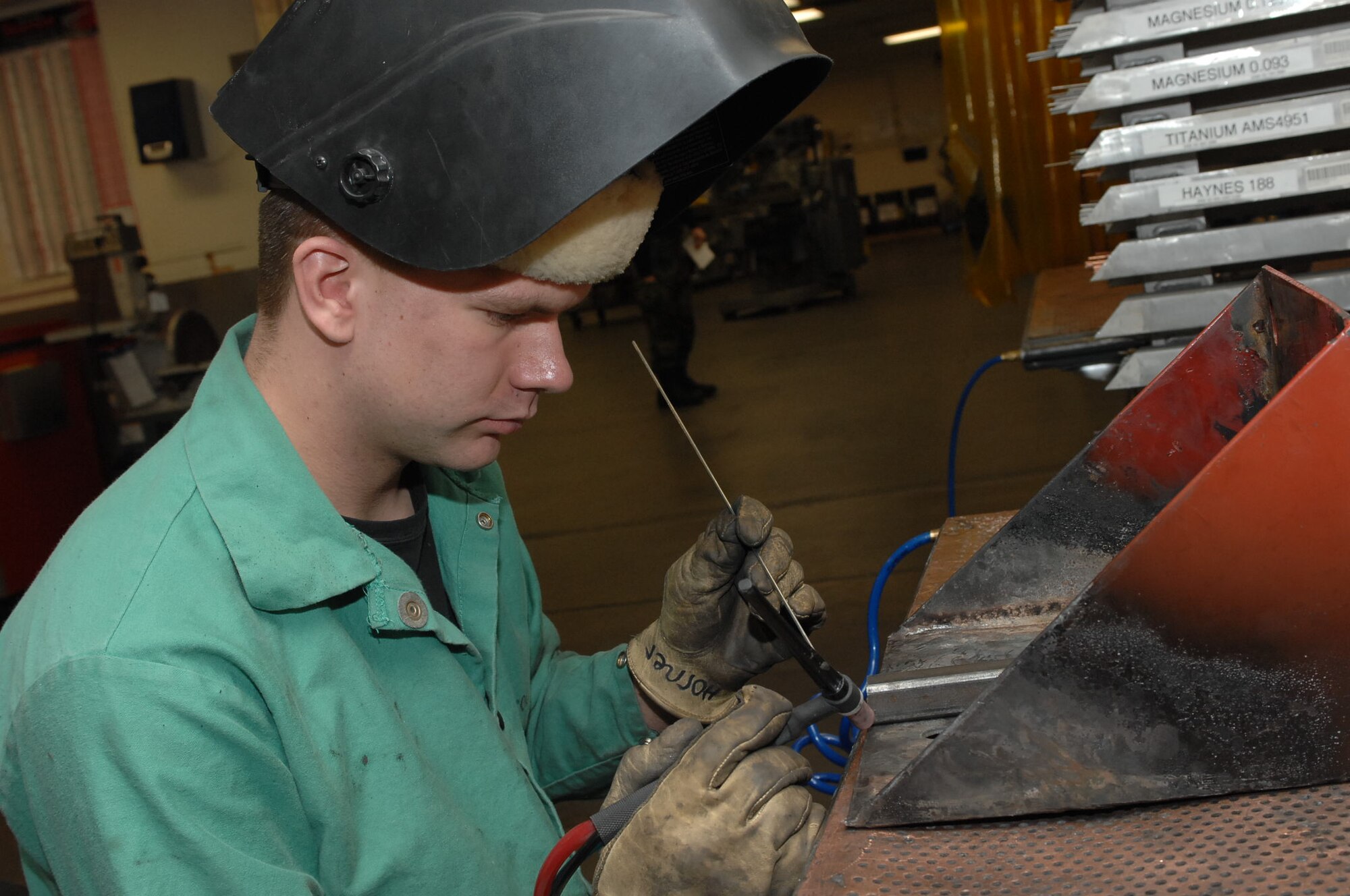 MOUNTAIN HOME AIR FORCE BASE, Idaho-- Airman Tyler Horner, 366th Equipment Maintenance Squadron aircraft metal technician, reinforces a steel bracket for a tractor snow plow during Phase I of Exercise Sharpshooter 08-03 here, Feb. 1.  Units across the base are participating in the exercise to prepare personnel and equipment for the upcoming March 2008 Operational Readiness Inspection. (U.S. Air Force photo/ Staff Sgt. Kathy Parker)