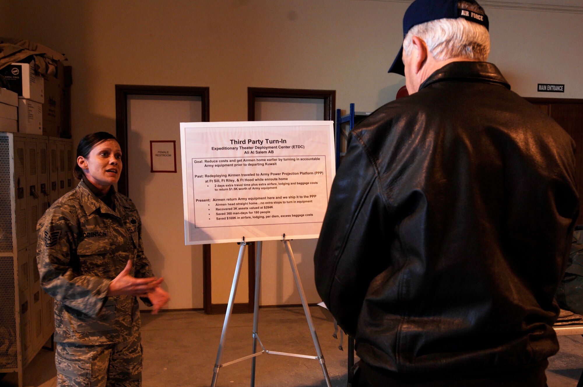 SOUTHWEST ASIA -- Tech. Sgt. Eugenia Robinson, a member of the 386th Expeditionary Logistics Readiness Squadron, briefs Secretary of the Air Force Michael Wynne, about the Expeditionary Theatre Deployment Center Feb. 1, 2008, during the SECAF’s visit to an air base in the Persian Gulf Region. Sergeant Robinson is the NCO in charge of one of three ETDCs in the region supporting Operations Enduring and Iraqi Freedom saving the Air Force approximately $17 million per rotation.  (U.S. Air Force photo/ Staff Sgt. Patrick Dixon)