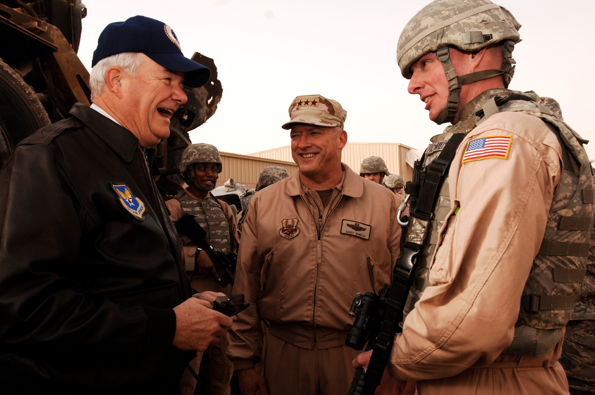 SOUTHWEST ASIA -- Secretary of the Air Force Michael Wynne, (left), Lt. Gen. Gary North, (center), U.S. Central Command Air Forces commander, share a laugh with Tech. Sgt. Douglas Schmidt, a convoy commander for the 586th Expeditionary Logistics Readiness Squadron, 424th Medium Truck Detachment, during the SECAF's visit to an air base in the Persian Gulf Region Feb. 1, 2008. The SECAF was briefed about Improvised Explosive Device attacks on convoys driven by Airmen in support of Operation Iraqi Freedom. The SECAF spoke with more than 400 Airmen during his visit and gained greater insight on the 6,800 plus Airmen deployed throughout Southwest Asia in non-traditional Air Force functions. (U.S. Air Force photo/ Staff Sgt. Patrick Dixon)