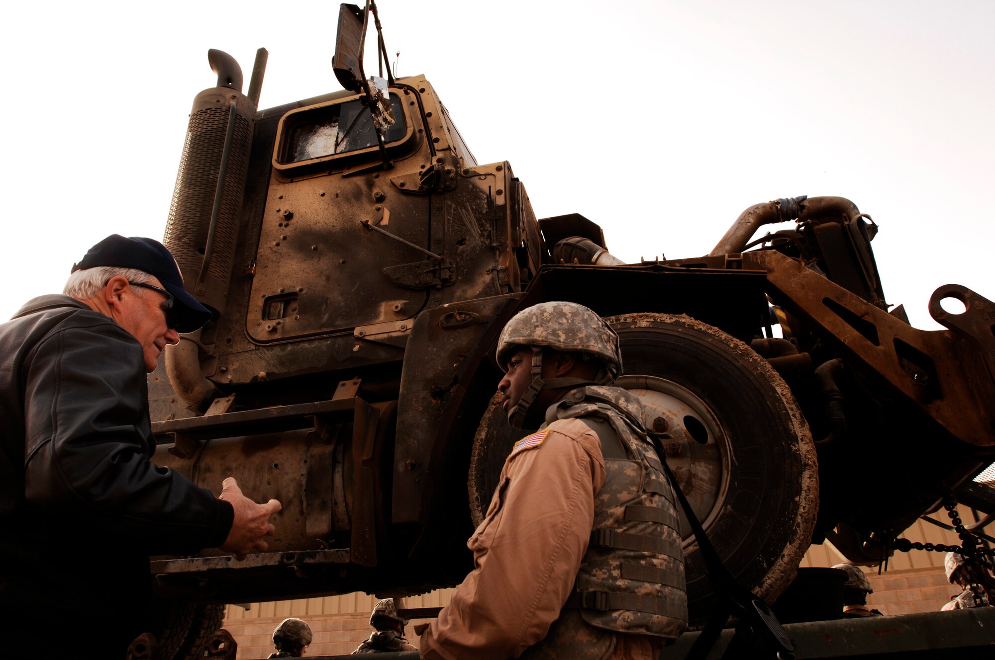 SOUTHWEST ASIA -- Master Sgt. Kory Hunter, (left), briefs Secretary of the Air Force Michael Wynne, about the Improvised Explosive Device damages to an M915 semi tractor trailer during the SECAFs visit to an air base in the Persian Gulf Region Feb. 1, 2008. Sergeant Hunter is a convoy commander for the 586th Expeditionary Logistics Readiness Squadron, 70th Medium Truck Detachment deployed in support of Operation Iraqi Freedom. The SECAF spoke with more than 400 Airmen during his visit and gained greater insight on the 6,800 plus Airmen deployed throughout Southwest Asia in non-traditional Air Force functions.  (U.S. Air Force photo/ Staff Sgt. Patrick Dixon)