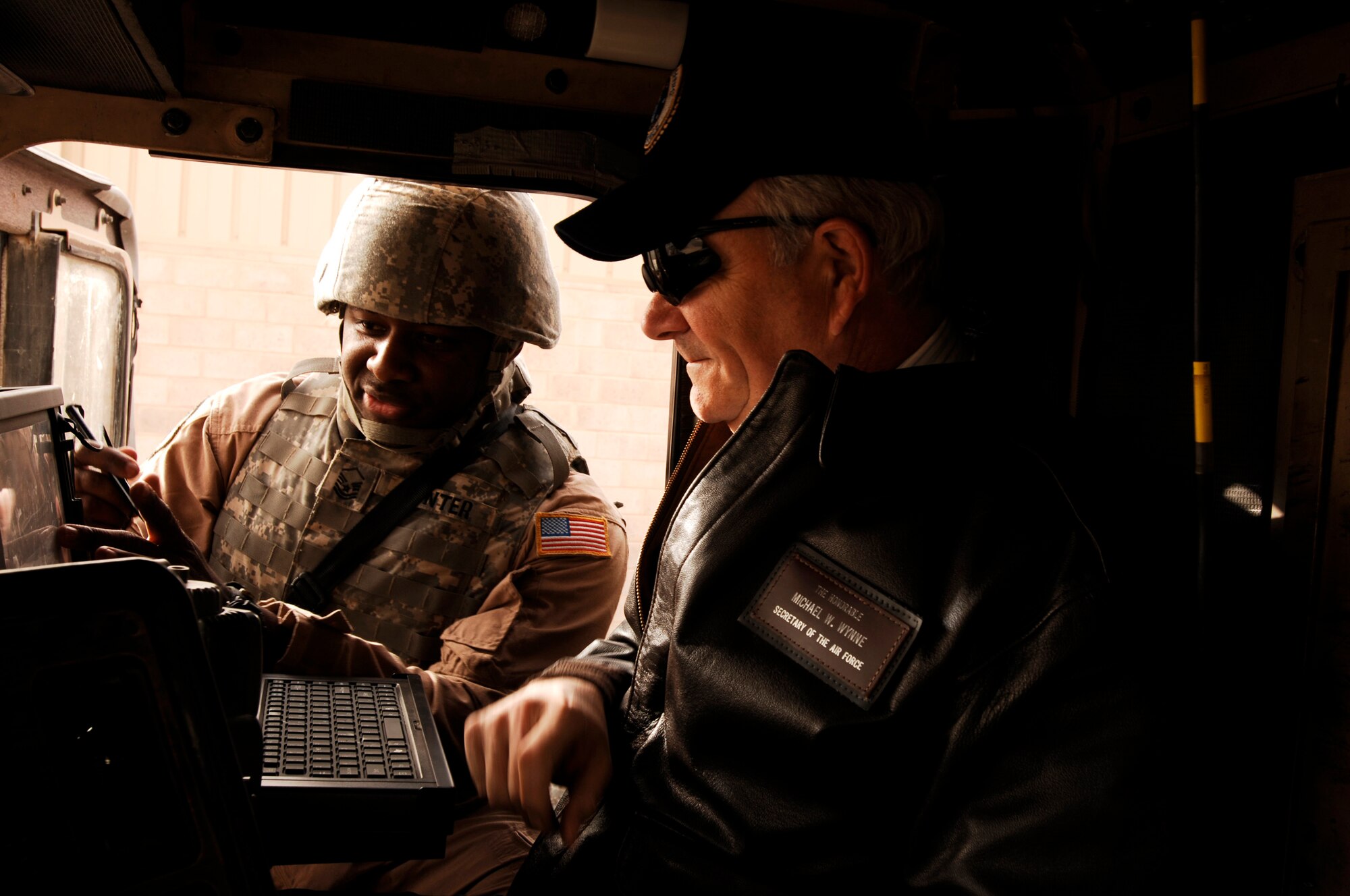 SOUTHWEST ASIA -- Master Sgt. Kory Hunter (left) briefs Secretary of the Air Force Michael Wynne, about the mobile tracking system inside a M915 semi tractor trailer during a display Feb. 1, 2008, during the SECAFs visit to an air base in the Persian Gulf Region. Sergeant Hunter is a convoy commander for the 586th Expeditionary Logistics Readiness Squadron's 70th Medium Truck Detachment deployed in support  of Operation Iraqi Freedom.  (U.S. Air Force photo/ Staff Sgt. Patrick Dixon)