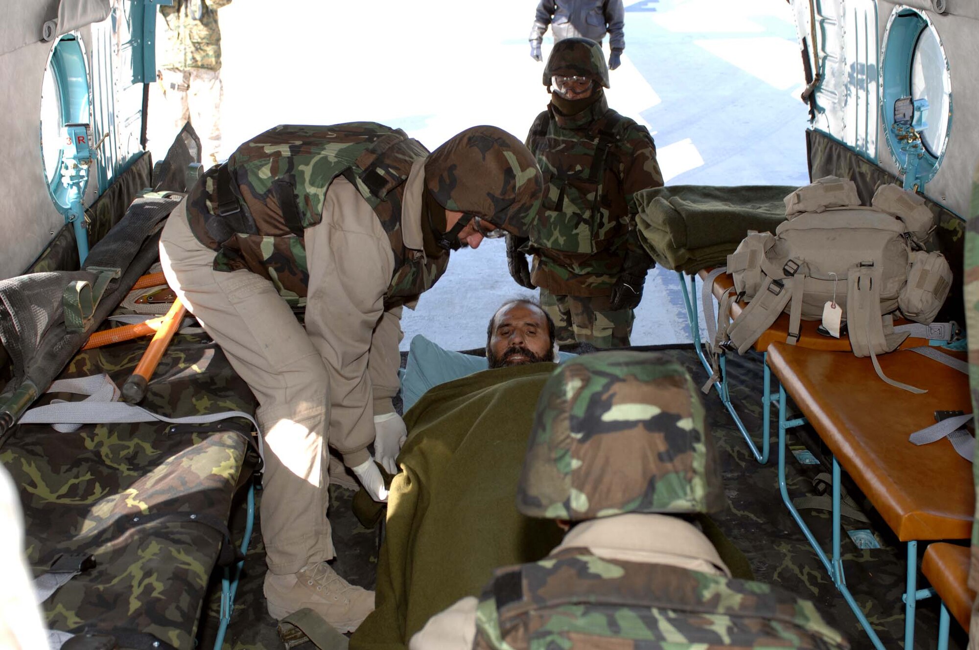 BAGRAM AIR BASE, Afghanistan-- Afghanistan National Army Soldiers secure a wounded comrade for transport during the first-ever medevac conducted solely by the ANA Jan. 31.  The patient was transported from the Craig Joint Theatre Hospital here to the Kabul International Airport.  (U.S. Air Force photo by MSgt. Demetrius Lester)