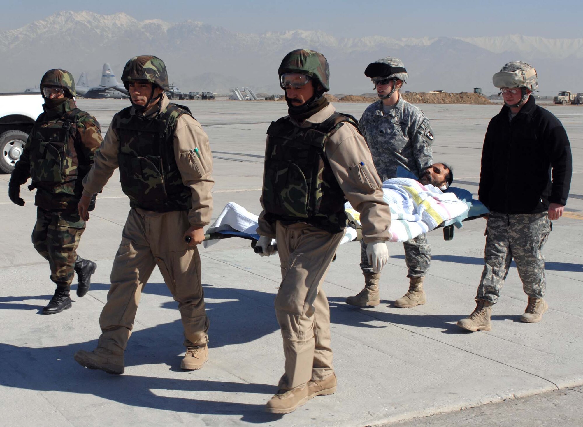 BAGRAM AIR BASE, Afghanistan—Afghanistan National Army Soldiers transfer a wounded comrade from an ambulance to a waiting ANA Mi-17 medevac-configured helicopter Jan. 31.  This was the first-ever medevac conducted solely by the ANA.  (U.S. Air Force photo by MSgt. Demetrius Lester)