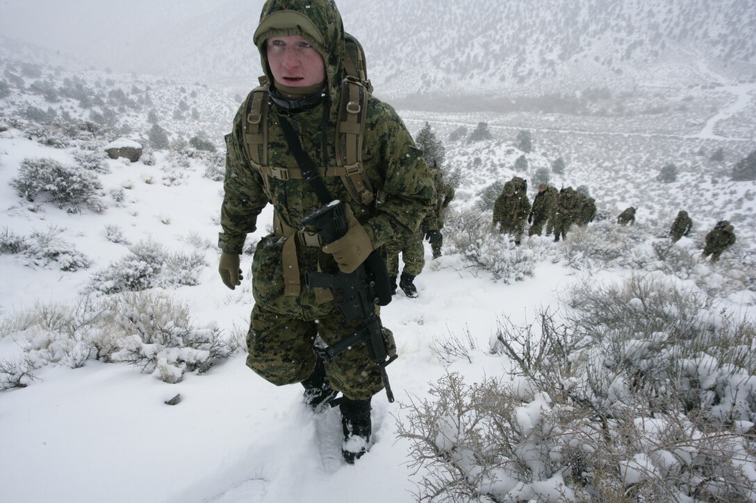 A U.S. Marine with Embedded Trainer Team 2-6, based out of Okinawa, Japan, climbs the foothills of a mountain during a dismounted mountain mobility course aboard U.S. Army training terrain in Hawthorne, Nev., Feb. 4, 2008.  Embedded training teams, made up of Marines and sailors serving with 3rd Marine Division, are preparing to face cold weather and mountainous elements for their upcoming deployment to Afghanistan.  Ultimately, the teams are training to take role as military advisors to units with the Afghan National Army when they deploy.  (U.S. Marine Corps photo by Cpl. Michael S. Cifuentes)