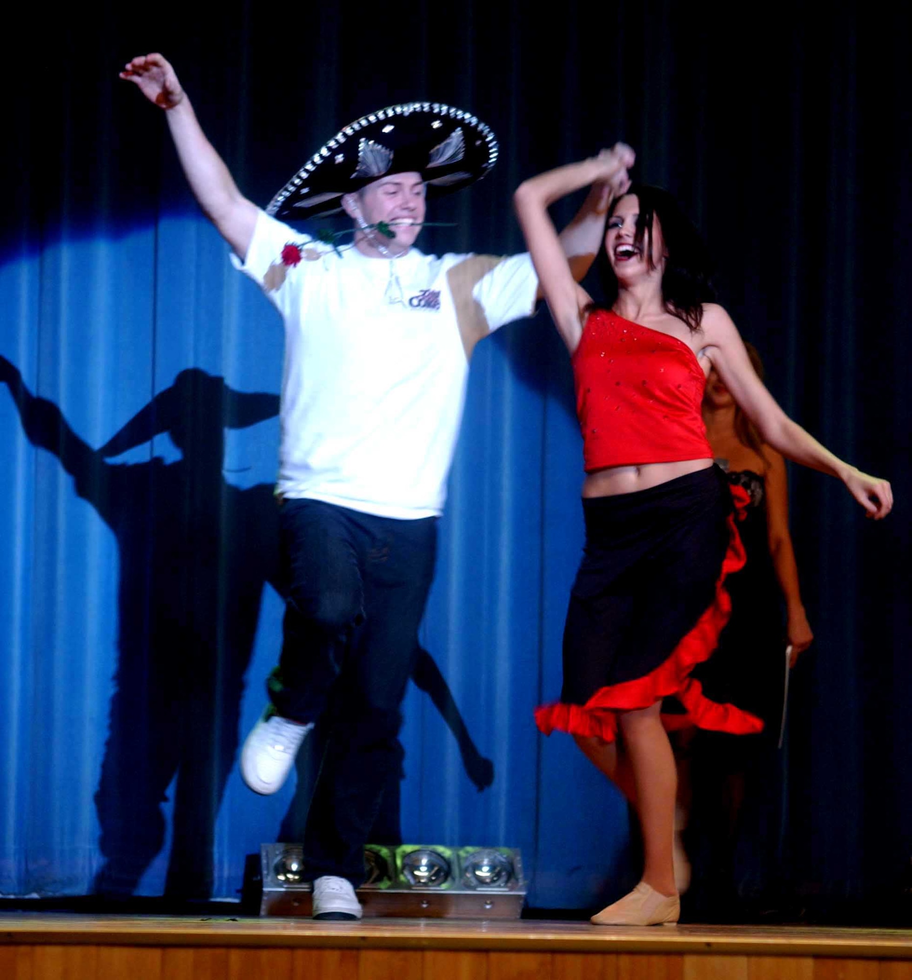 OSAN AIR BASE, Republic of Korea -- Airman 1st Class Chip Weed, 51st Logistics Readiness Squadron, dances the salsa with a member of the Arizona Cardinals Show Team during the team's performance at Osan's Base Theater Feb. 2. Airman Weed, a native of Walla Walla, Wash., was the winner of the salsa dance contest. (U.S. Air Force photo/Staff Sgt. Candy Knight)