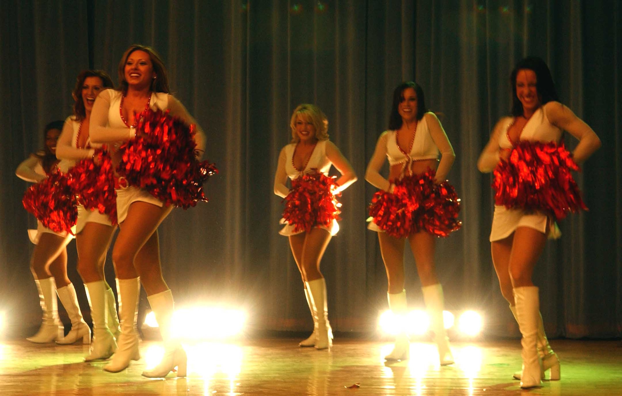 OSAN AIR BASE, Republic of Korea -- Members of the Arizona Cardinals Show Team perform at the Osan Base Theater Feb. 2.  The team consists of current members of the cheerleading squad, which has performed for many events throughout the world. The show included an array of dances and audience participation games. (U.S. Air Force photo/Staff Sgt. Candy Knight)