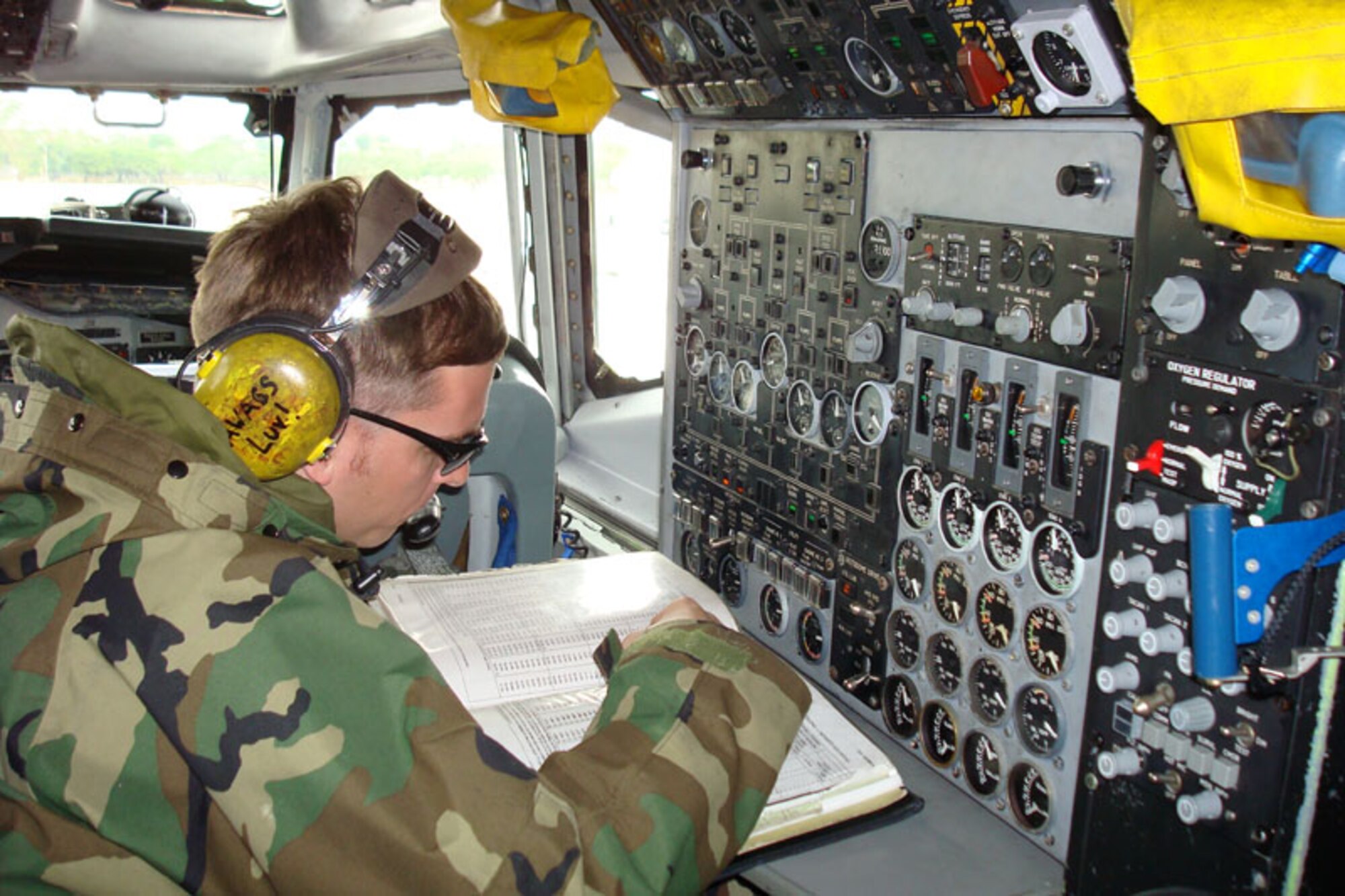 Master Sgt. Zerian Moore, lead production superintendent of the 961st Airborne Air Control Squadron (AACS), of Kadena Air Base, Japan, reviews electronic technical orders, a part of post-flight maintenance with his squadron maintainers after an E-3 Sentry (AWACS) landed. Aircrew from the 961st and 962nd (Elmendorf Air Force Base, Alaska) AACS  worked together to perform a quick turnaround to ground-refuel an E-3 Sentry and still complete a mission Feb. 3. (U.S. Air Force photo/Capt. Renee H. Lee)