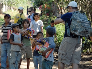 SOTO CANO AIR BASE, Honduras--A member of Joint Task Force-Bravo takes a digital image of his new friends during a Feb. 2 hike into the mountains surrounding Comayagua, Honduras. More than 60 JTF-Bravo personnel deliverd more than 2,000 pounds of food to local Hondurans during a Chapel Hike which allows JTF-Bravo personnel the opportunity to see the countryside as well as interact with locals.  