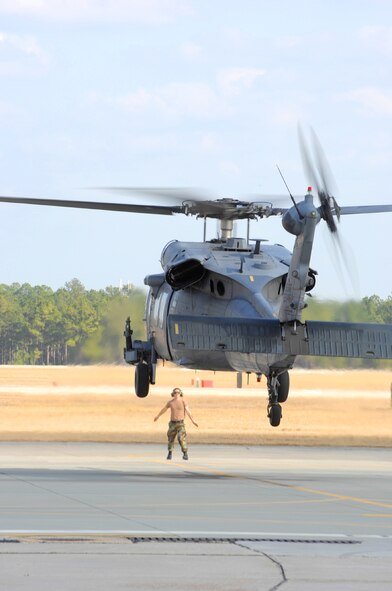 MOODY AIR FORCE BASE, Ga. — Senior Airman Jason Chavies, 723rd Aircraft Maintenance Squadron HH-60G Pave Hawk crew chief, guides a 41st Rescue Squadron HH-60G down for landing Feb 4.  As a crew chief, Airman Chavies primary duty is servicing and inspecting the aircraft to keep it ready for flight. (U.S. Air Force photo by Senior Airman Angelita Lawrence) 