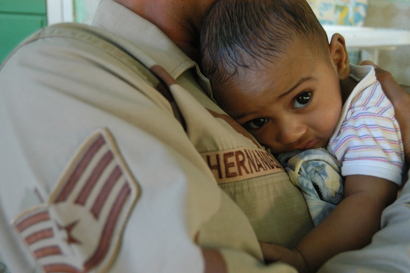 DJIBOUTI – Air Force Staff Sgt. Francisco J. Hernandez cuddles with a baby at the Djibouti baby orphanage Jan. 26. Hernandez is the Combined Joint Task Force-Horn of Africa Information Management Office Data Systems noncommissioned officer in charge. The Merkel, Texas, native, is among servicemembers from Camp Lemonier, Djibouti, who donate their time to visiting the facility three times a week to help feed and play with the children. The orphanage houses more than 60 babies and toddlers. (U.S. Air Force photo/Staff Sgt. Jennifer Redente)
