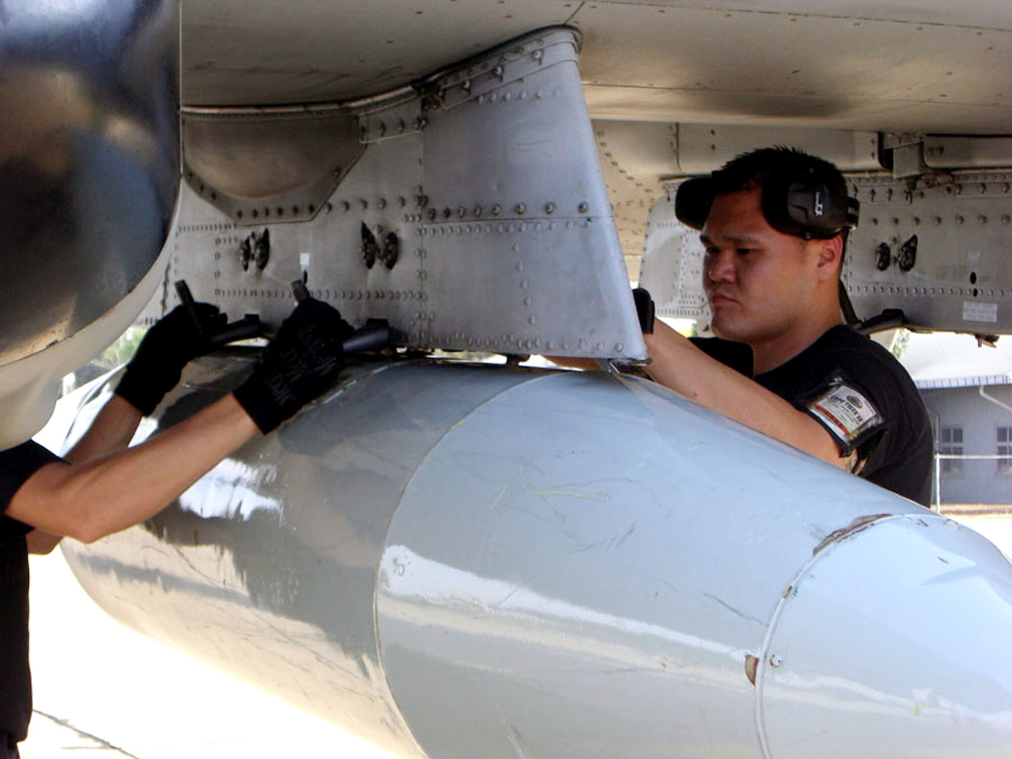 Senior Airman Paul Tamura downloads travel pods from an A-10 Thunderbolt II after its arrival Jan. 27 at the Korat Royal Thai Air Base, Thailand, from Osan Air Base, South Korea. Six A-10s from the 25th Fighter Squadron arrived in Thailand to participate in Exercise Cope Tiger 2008. Airman Tamura is a weapons load crew member in the 51st Aircraft Maintenance Squadron of the 51st Fighter Wing, at Osan AB.  The Thai-, Singaporean- and U.S.-hosted exercise enhances combined readiness and interoperability, reinforces U.S. commitment to the Southeast Asian region and demonstrates U.S. capability to project combined and joint forces strategically in a multilateral environment. (U.S. Air Force photo/Capt. Renee Lee) 