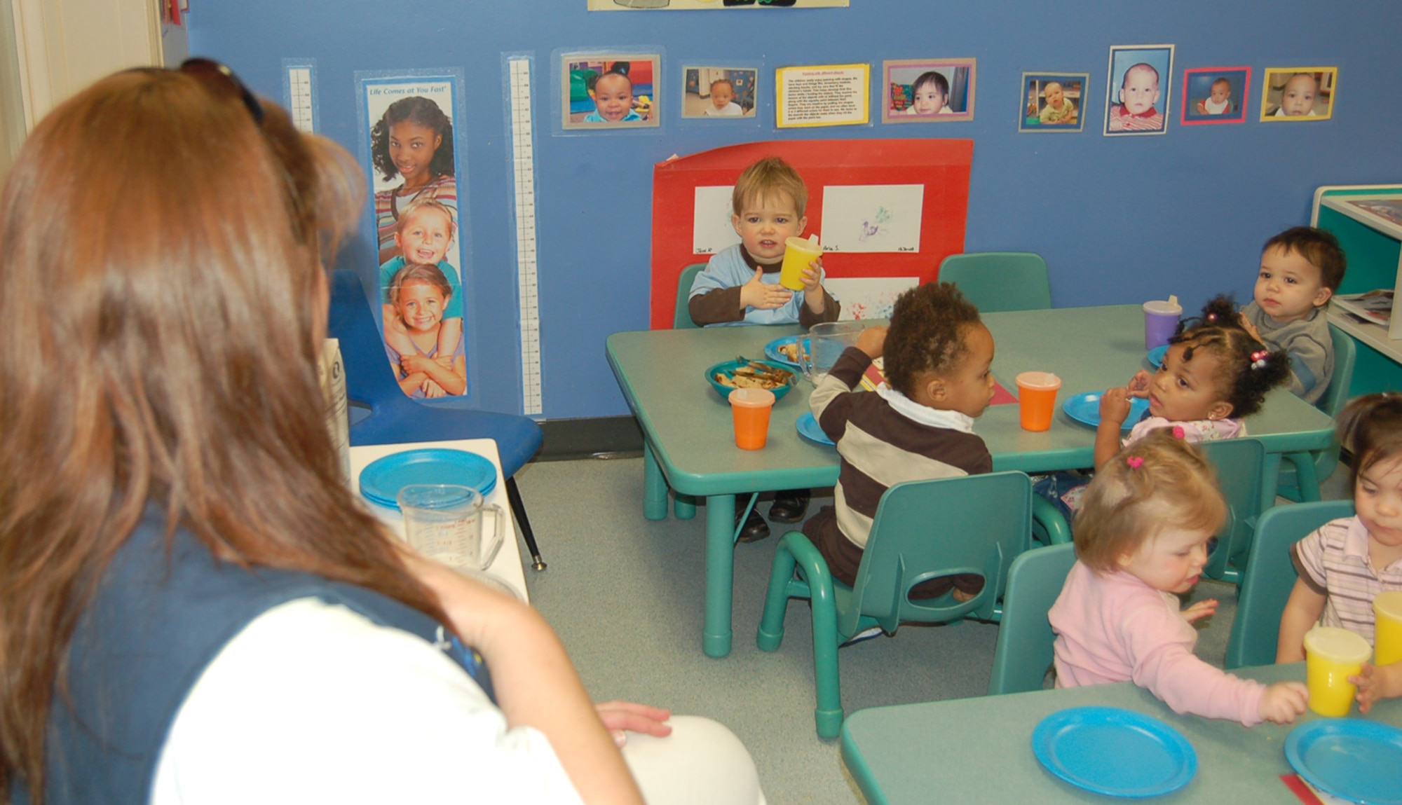 Jack Roberts, 20 months, signals ‘thank you’ to teacher Rhonda Boyer during snack time Jan. 31. Children at Peterson’s Child Development Center are learning to sign simple words as part of the Baby Signs program. (U.S. Air Force photo/Corey Dahl)