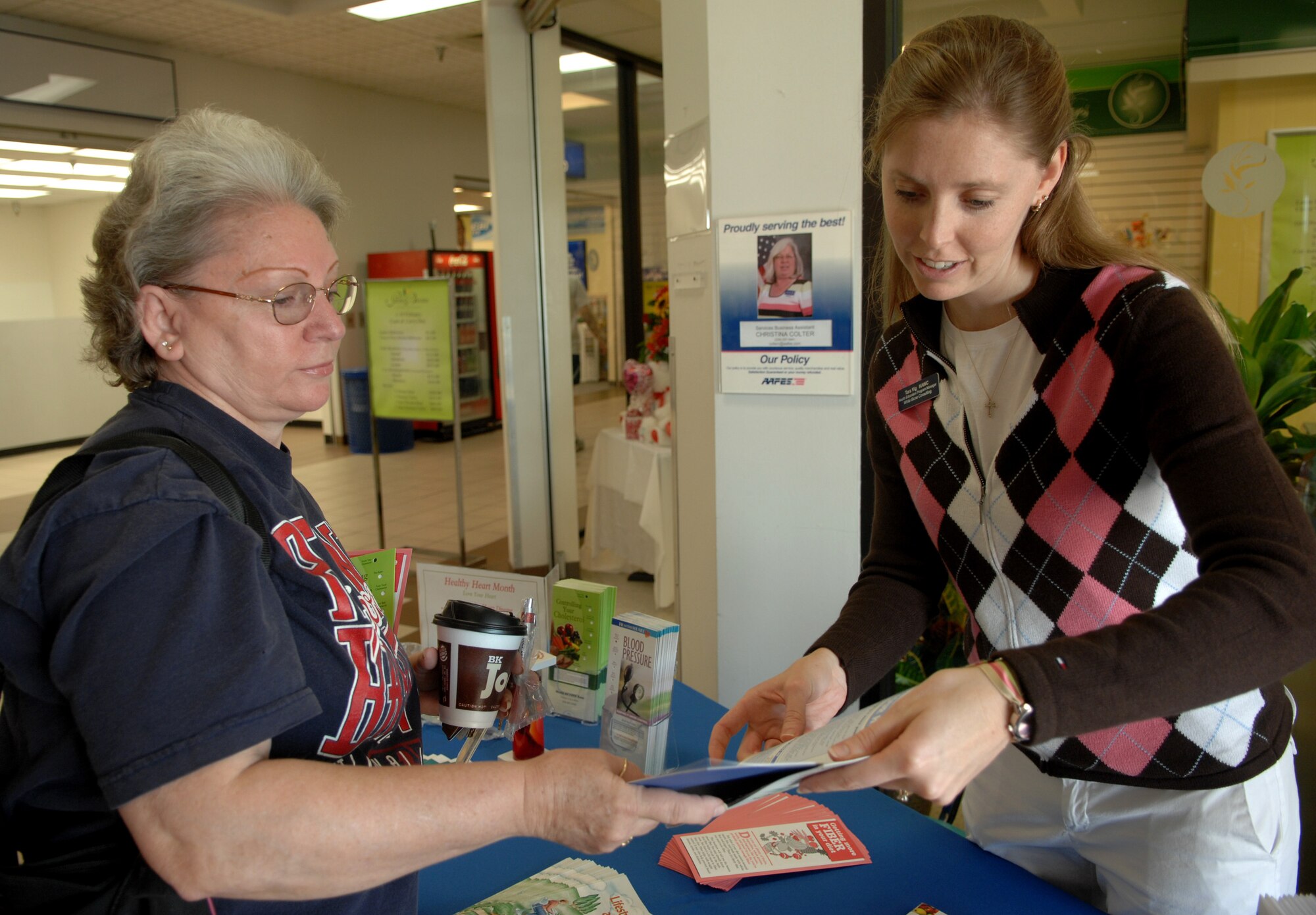 MOODY AIR FORCE BASE, Ga. -- Tara Vig, Health and Wellness Center health education program manager, hands a healthy heart month flyer to Lois Parrott at the Moody base exchange Feb. 4. The HAWC provides many programs to help keep Team Moody healthy. (U.S. Air Force photo by Airman 1st Class Gina Chiaverotti)