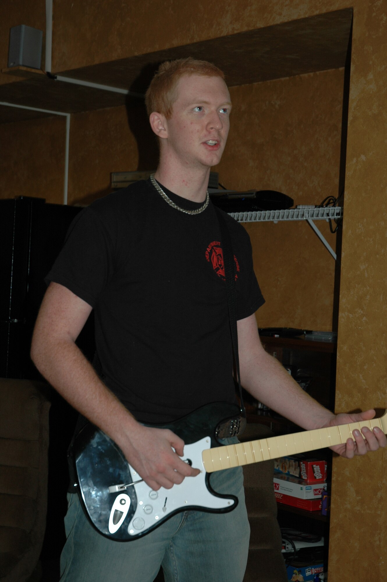 Airman 1st Class Zachary Kuiper, 325th Civil Engineer Squadron firefighter, plays the guitar from the game Rockband in the Living Room at Tyndall.  The Living Room is a place created for the Tyndall dorm residents to hang out and get to know one another.  (U.S. Air Force photo by Airman 1st Class Veronica McMahon)