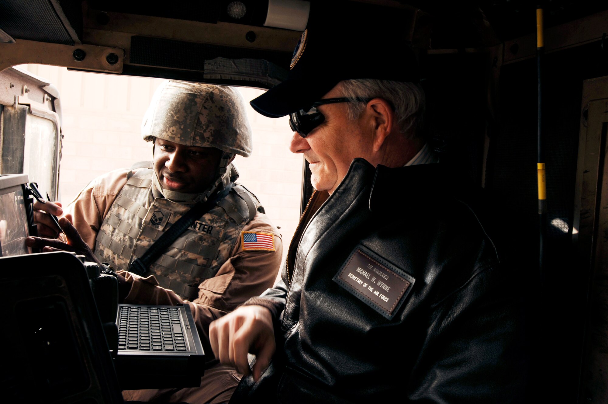 Master Sgt. Kory Hunter briefs Secretary of the Air Force Michael Wynne about the mobile tracking system inside a M915 semi-tractor trailer during the SECAFs visit Feb. 1. The SECAF spoke with more than 400 Airmen during his visit and gained greater insight on the 6,800 plus Airmen deployed throughout Southwest Asia in non-traditional Air Force functions. Sergeant Hunter is a convoy commander from the 586th Expeditionary Logistics Readiness Squadron, 70th Medium Truck Detachment. (U.S. Air Force photo/Senior Airman Patrick Dixon)