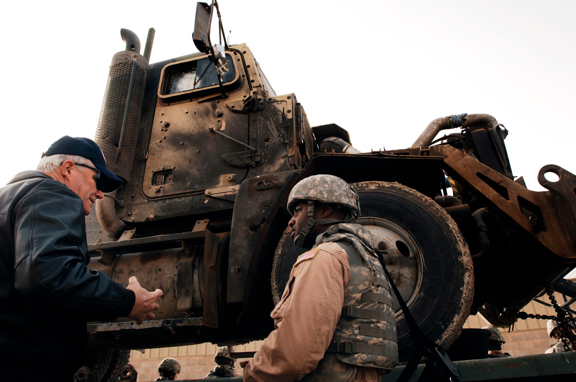 Master Sgt. Kory Hunter (left) briefs Secretary of the Air Force Michael Wynne about the damage done to a M915 semi-tractor trailer from an improvised explosive device  during the SECAFs visit to Southwest Asia Feb. 1. The SECAF spoke with more than 400 Airmen during his visit and gained greater insight on the 6,800 plus Airmen deployed throughout Southwest Asia in non-traditional Air Force functions. Sergeant Hunter is a convoy commander from the 586th Expeditionary Logistics Readiness Squadron, 70th Medium Truck Detachment. (U.S. Air Force photo/Senior Airman Patrick Dixon)