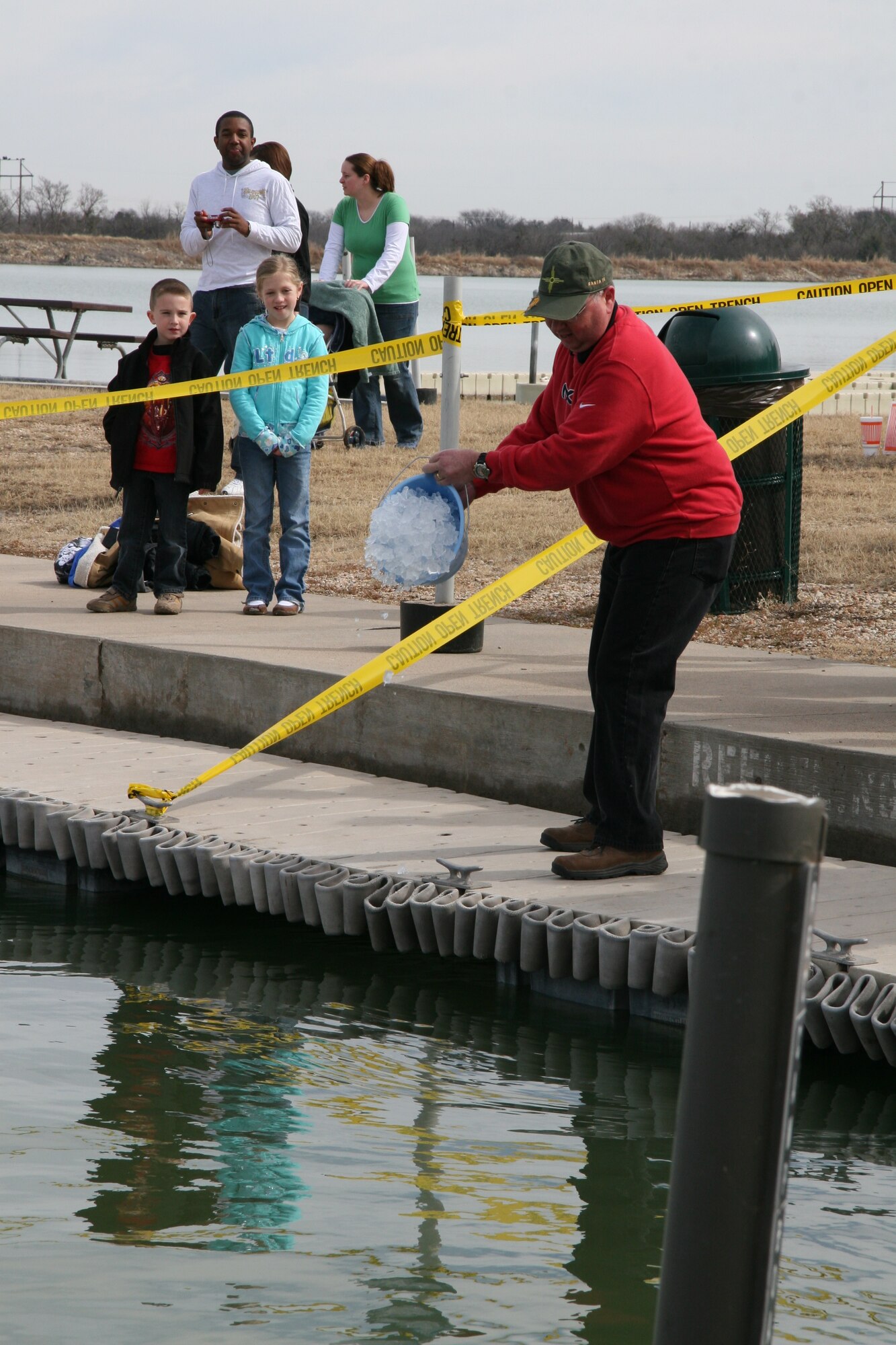 Ensuring the water at Lake Nasworthy is cold enough for the Polar Bear Swim is Col. Richard Ayres, 17th Training Wing commander. The Polar Bear Swim, which took place Jan. 26, tests the endurance of participants from Goodfellow as they leap into near-freezing water and swim to shore. (U.S. Air Force photo by Julie Manuel)