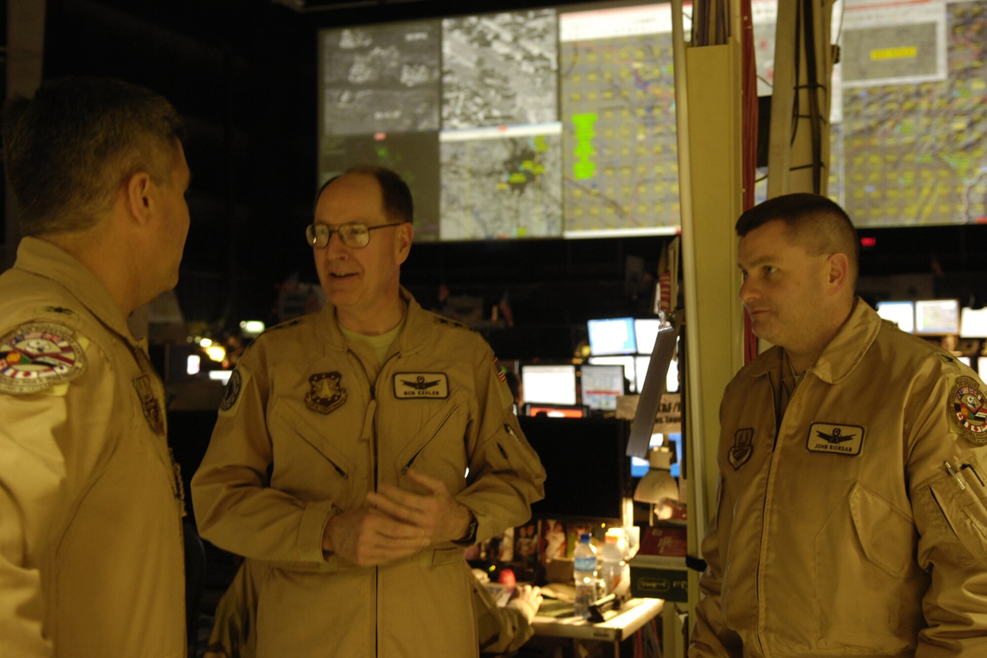 General C. Robert “Bob” Kehler, Air Force Space Command commander (middle), receives a briefing on the Combined Air and Space Operations Center from Col. Gary Crowder, 609th Air Operations Center commander, and Col. John Riordan, Director of Space Force, Feb. 2 in Southwest Asia. (U.S. Air Force photo by Staff Sgt. Christina M. Styer)
