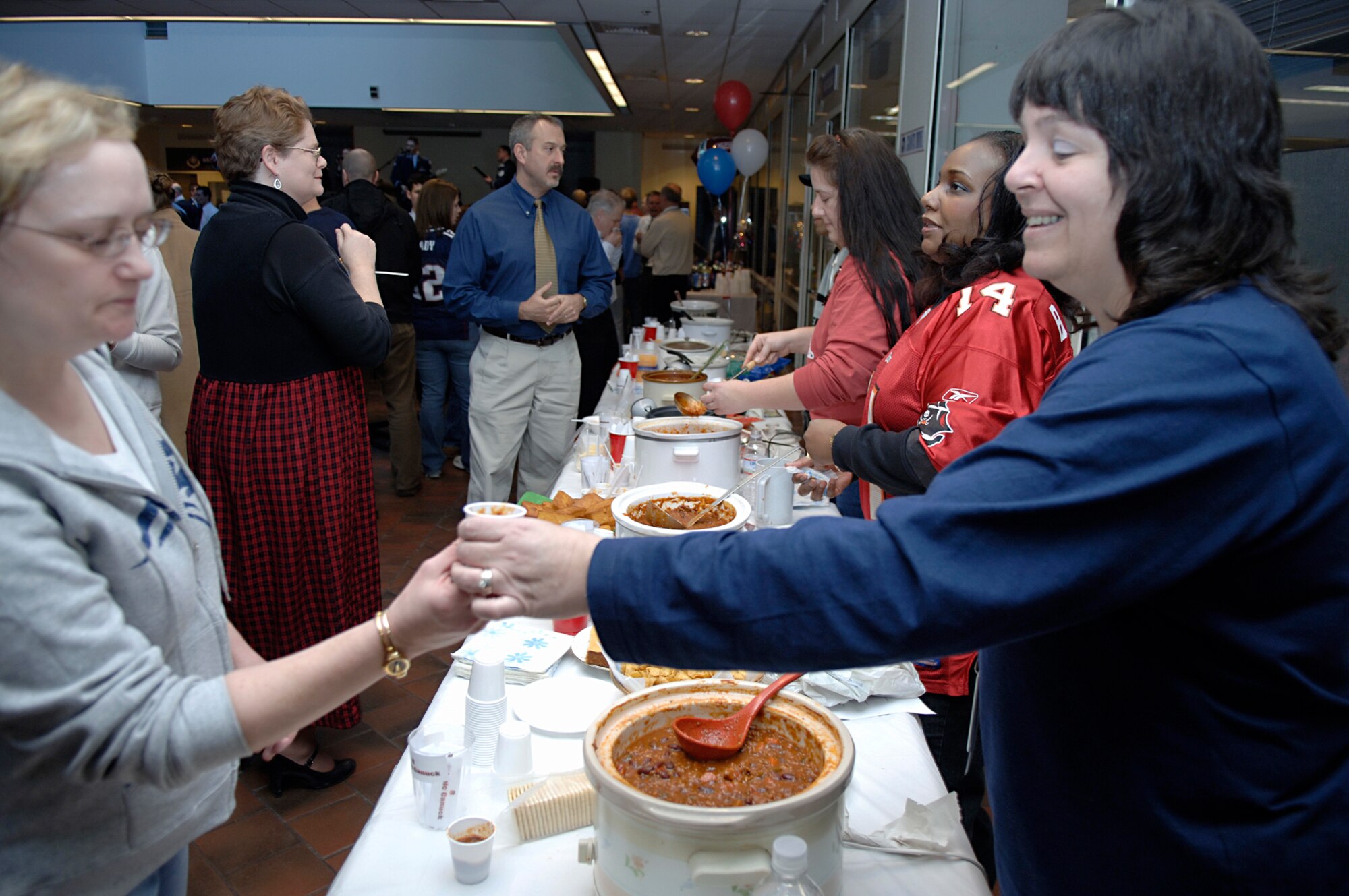 HANSCOM AFB, Mass. – The Electronic Systems Center Contracting Office hosted a pre-Super Bowl party on Jan. 31 in the atrium of the O’Neill Building. The party featured entertainment from the Air Force Band of Liberty’s rock group, Afterburner and a chili cook off. The Wingman event allowed attendees to socialize and show their team pride.   (U.S. Air Force photo by Jan Abate)
