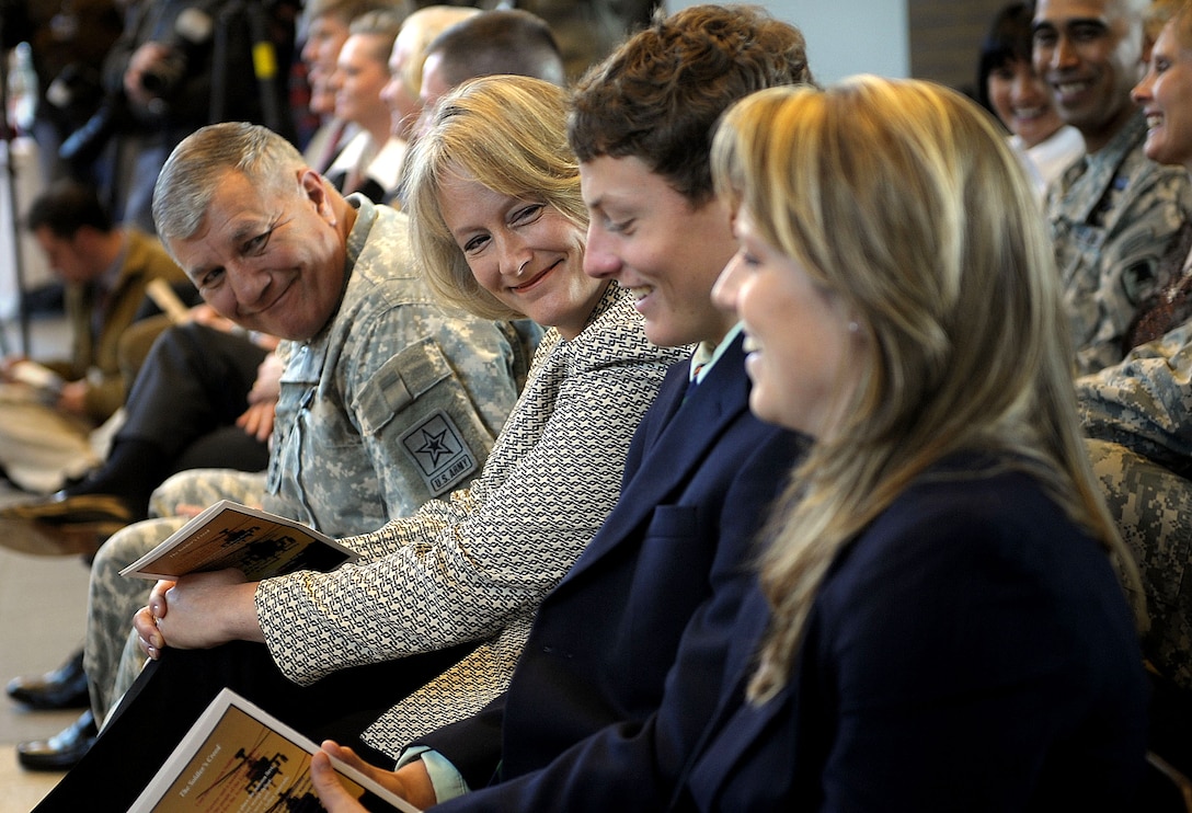 Gen. Richard A. Cody, Army vice chief of staff, and Hollyanne Milley, wife of Brig. Gen. Mark Milley, smile at the Milleys' children, Peter and Mary, as their father speaks about them during his promotion ceremony on Fort Campbell, Ky., Feb. 1, 2008.  