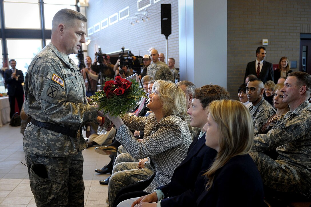Brig. Gen. Mark Milley, deputy commander of operations for the 101st Airborne Division Air Assault, gives flowers to his wife, Hollyanne, and thanks her for her support during his promotion ceremony on Fort Campbell, Ky., Feb. 1, 2008.  