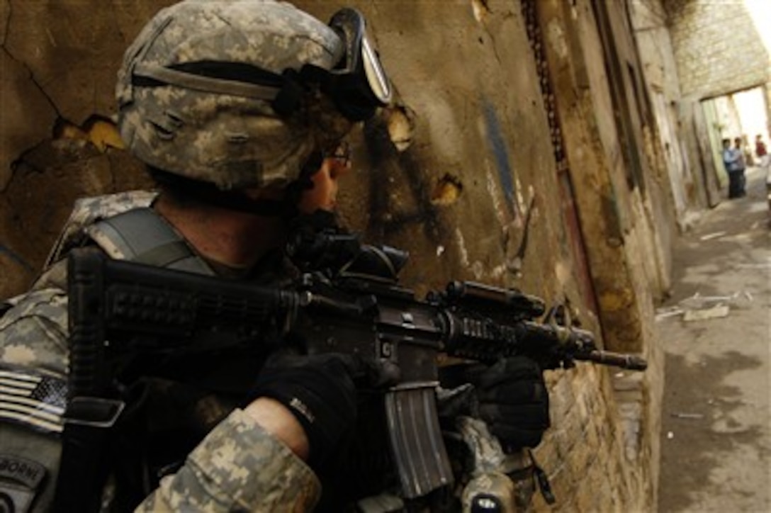 A U.S. Army soldier assigned to 3rd Platoon, Charlie Company, 1st Battalion, 504th Parachute Infantry Regiment provides security while his platoon searches a house for a possible improvised explosive device cache in Baghdad, Iraq, on Jan. 28, 2008.  
