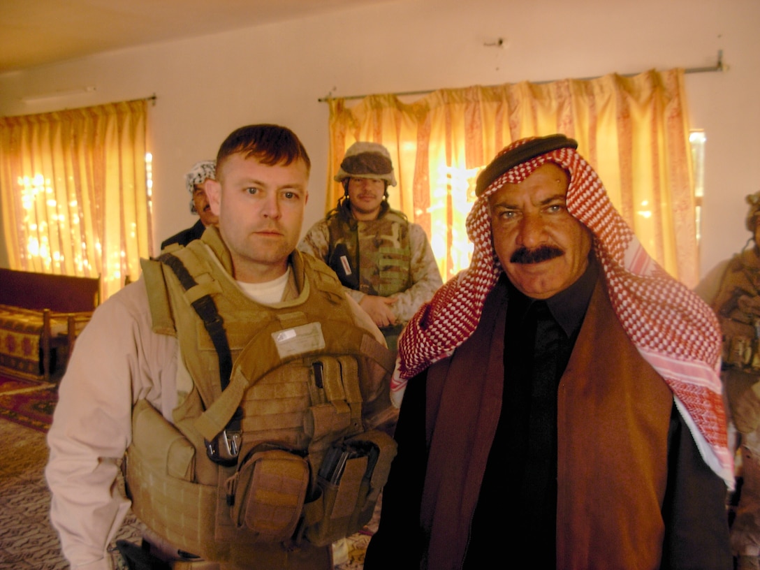 First Sgt. Terry W. Bradley, senior enlisted advisor for Task Force Guardian, Headquarters Battalion, II Marine Expeditionary Force (Forward), stands with Sheik Hekmit in a home outside of Fallujah, Iraq.  Bradley was later awarded the Bronze Star Medal for his contribution to the successful deployment of Task Force Guardian to Al Anbar Province.  (Photo courtesy of 1st Sgt. Terry W. Bradley)(RELEASED)