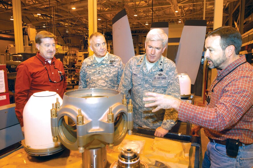 Tim Annis, 572nd Commodities Maintenance Group director, Maj. Gen. William Nesbitt, adjutant general, Georgia, and Maj. Gen. Tom Owen, Warner Robins Air Logistics Center commander listen to J. D. White, 572nd Aircraft Component Squadron, propeller flight director talk about a prop barrel in the C-130 prop shop. U. S. Air Force photo by Sue Sapp                             