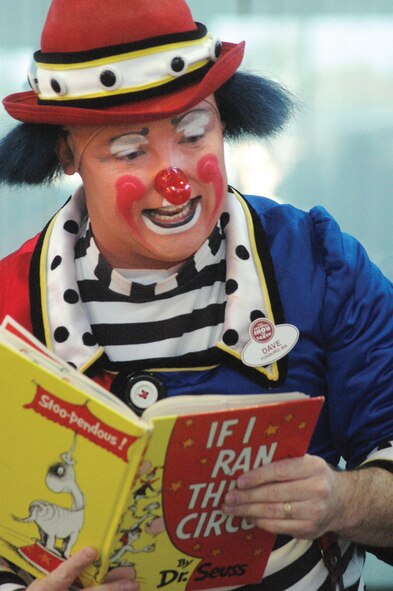 Dave, a Ringling Brothers and Barnum and Bailey Ambassador of Laughter, reads "If I Ran The Circus" by Dr. Seuss to children at the Base Library Jan. 2.  U. S. Air Force photo by Sue Sapp  