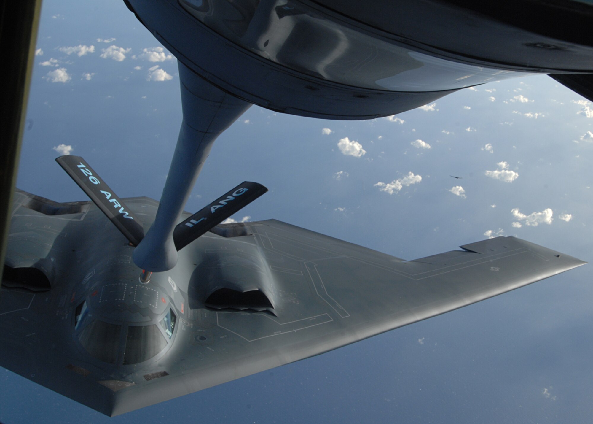 ANDERSEN AIR FORCE BASE, Guam-- A KC-135 from 126th Air Refueling Wing, Scott Air Force Base, Il. delivers fuel over the Philippine Sea during a routine refueling mission for the 393rd Expeditionary Bomb Squadron B-2 Spirit bombers from Whiteman AFB, Mo. The KC-135’s ability to refuel planes mid-air helps accomplish The Air Force's primary missions of Global Reach and Global Power. (U.S. Air Force Photo by Staff Sergeant Vanessa Valentine)