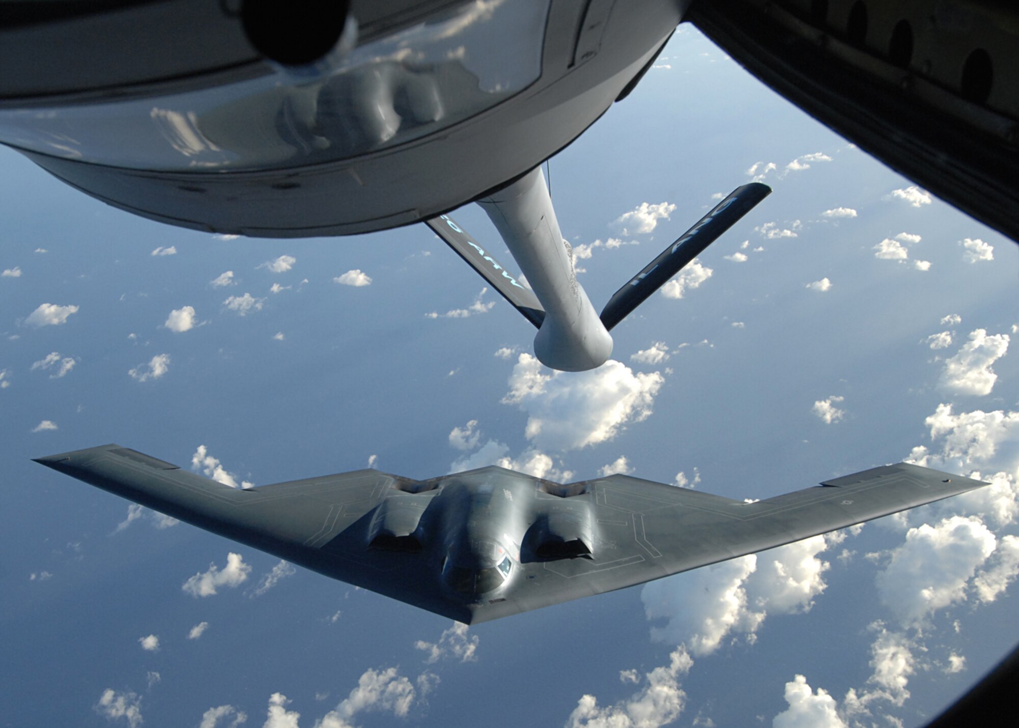 ANDERSEN AIR FORCE BASE, Guam-- A KC-135 from 126th Air Refueling Wing, Scott Air Force Base, Il.  delivers fuel over the Philippine Sea during a routine refueling mission for the 393rd Expeditionary Bomb Squadron B-2 Spirit bombers from Whiteman AFB, Mo.  The KC-135’s ability to refuel planes mid-air helps accomplish The Air Force's primary missions of Global Reach and Global Power. (U.S. Air Force Photo by Staff Sergeant Vanessa Valentine)