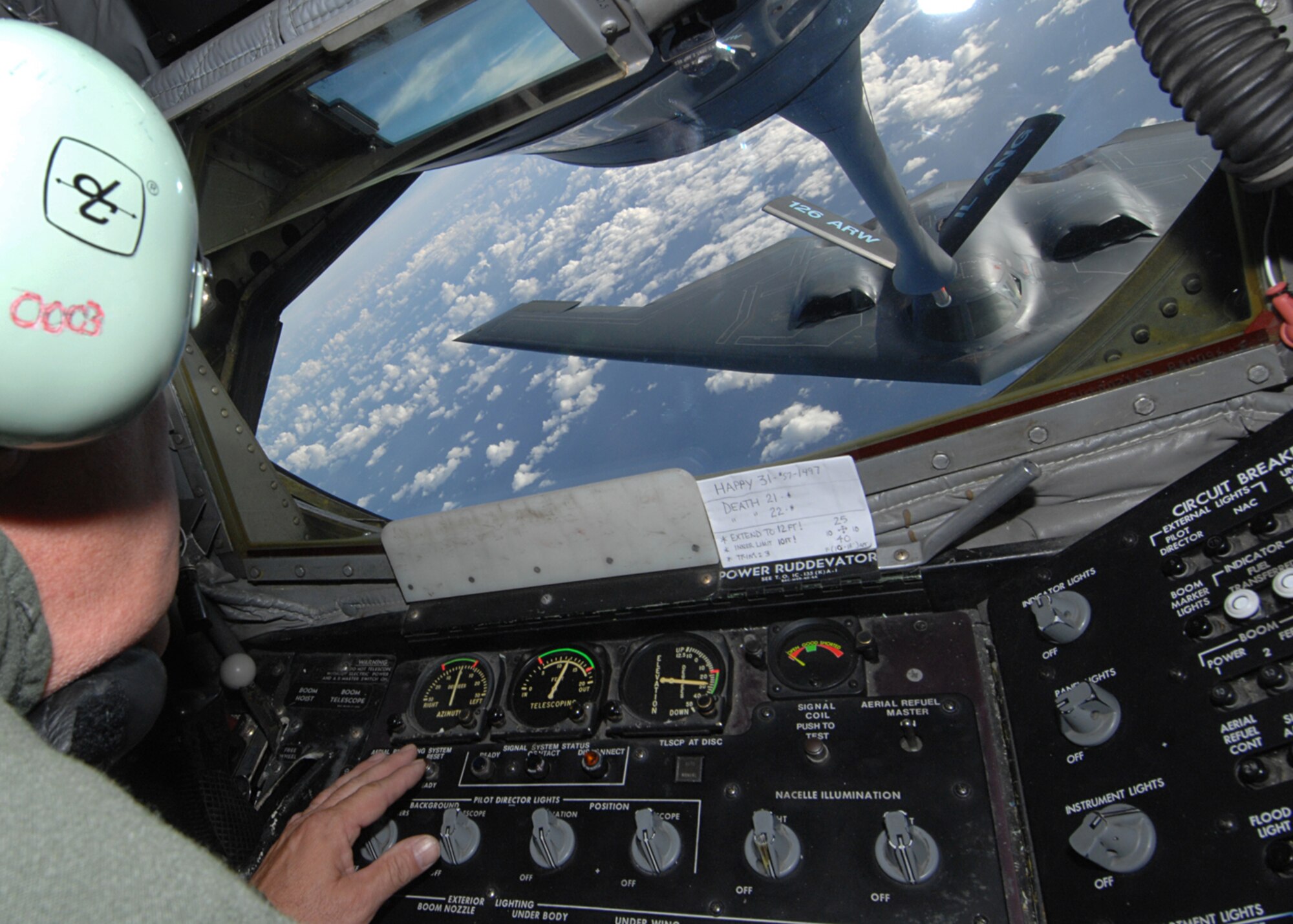 ANDERSEN AIR FORCE BASE, Guam-- KC-135 boom operator, Senior Maser Sgt.  Keith Wagner, 126th Air Refueling Wing, Scott Air Force Base, Il.  delivers fuel over the Philippine Sea during a routine refueling mission for the 393rd Expeditionary Bomb Squadron B-2 Spirit bombers from Whiteman AFB, Mo.  The KC-135’s ability to refuel planes mid-air helps accomplish The Air Force's primary missions of Global Reach and Global Power. (U.S. Air Force Photo by Staff Sergeant Vanessa Valentine)