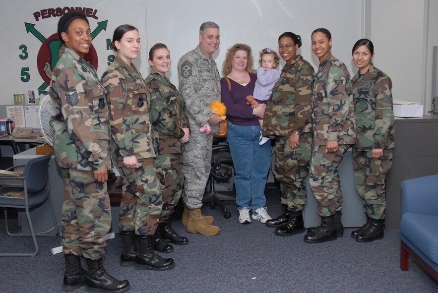 MISAWA AIR BASE, Japan -- Chief Master Sgt. Ricky Price, 35th Fighter Wing command chief, his wife Joan, and daughter Makayla pose with members of the 35th Mission Support Squadron career development office here, Jan. 29, 2008.  Chief Price recently arrived here and said he welcomes people to come and say hello to him and his family.  (U.S. Air Force photo by Senior Airman Laura R. McFarlane)