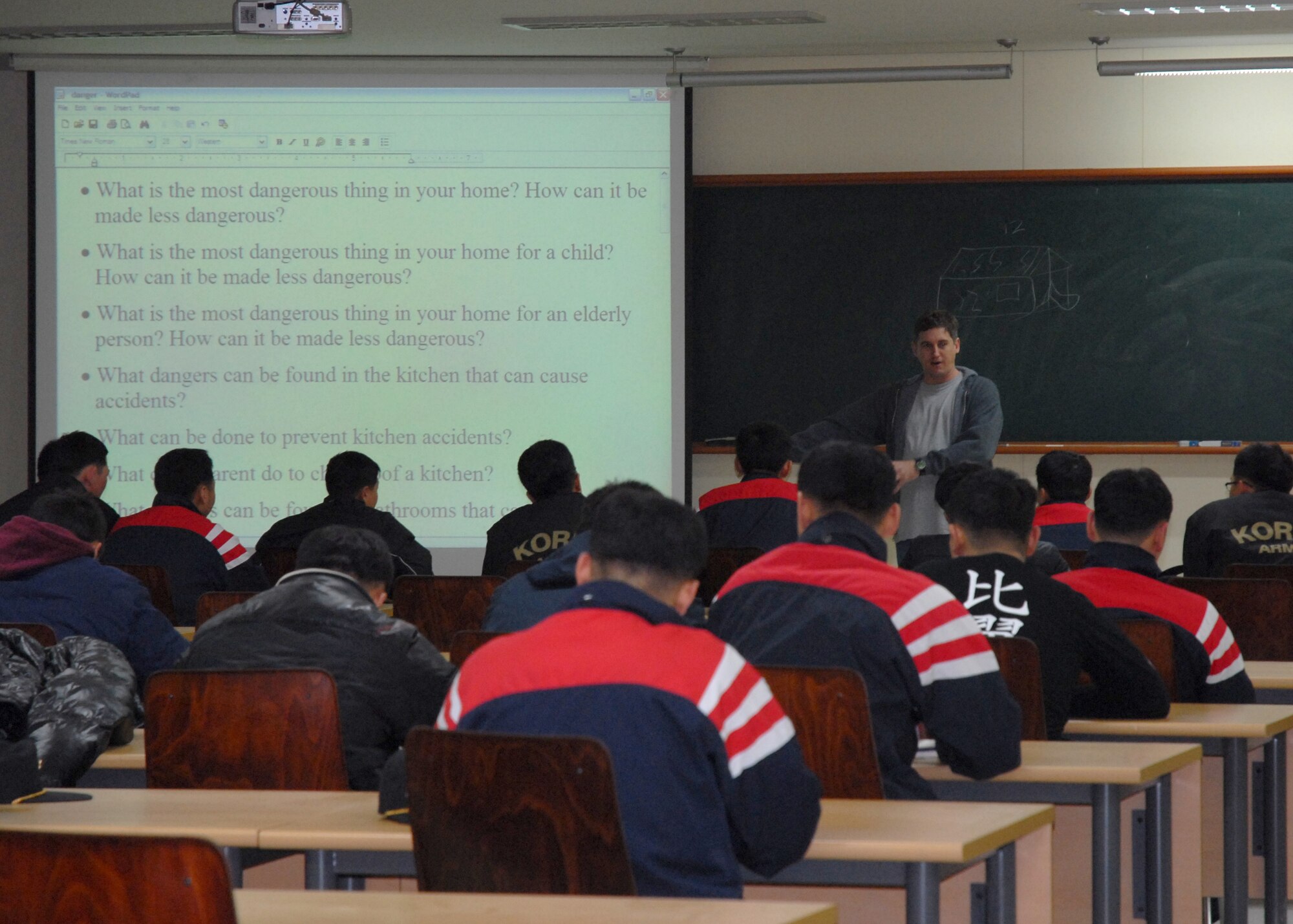 KUNSAN AIR BASE, South Korea -- Technical Sgt. Stephen Peterson interacts with students by asking questions about things that interest them here 31 Jan. Numerous Airmen from the 5/6 group take the opportunity throughout the year to assist ROK Cadets in learning English as part of the academy’s curriculum.  Sergeant Peterson is the assistant non-commissioned officer in charge of radar maintenance with the 8th Communications squadron. (U.S. Air Force Photo/Staff Sgt Araceli Alarcon)