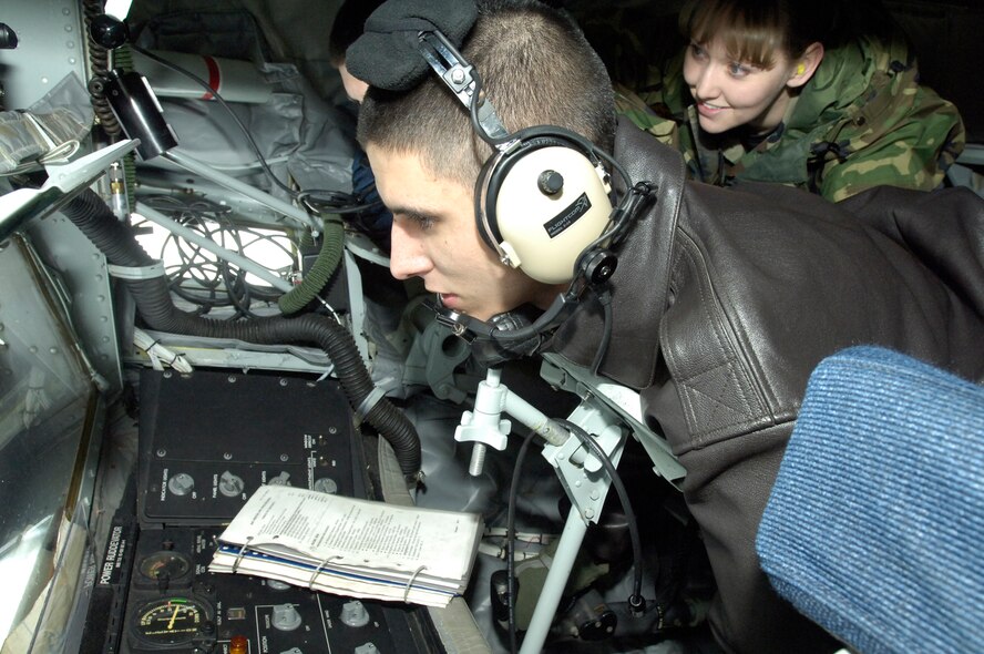 FAIRCHILD AIR FORCE BASE, Wash. – Senior Airman Bryan Wilson, 93rd Air Refueling Squadron boom operator, demonstrates boom operations to Staff Sgt. Cassaundra Preston, 92nd Maintenance Operations Squadron, during an incentive flight Feb. 4. Annual awards winners were taken on a three hour flight to congratulate them on their achievements. (U.S. Air Force photo/Senior Airman Eunique Stevens)