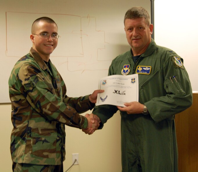 LAUGHLIN AIR FORCE BASE, Texas – Airman 1st Class Luke Scott, 47th Security Forces Squadron receives Laughlin’s XLer award from Col. Laro Clark, 47th Flying Training Wing Vice Commander, at the 47th SFS Jan. 29.(U.S. Air Force photo by Airman 1st Class Sara Csurilla)