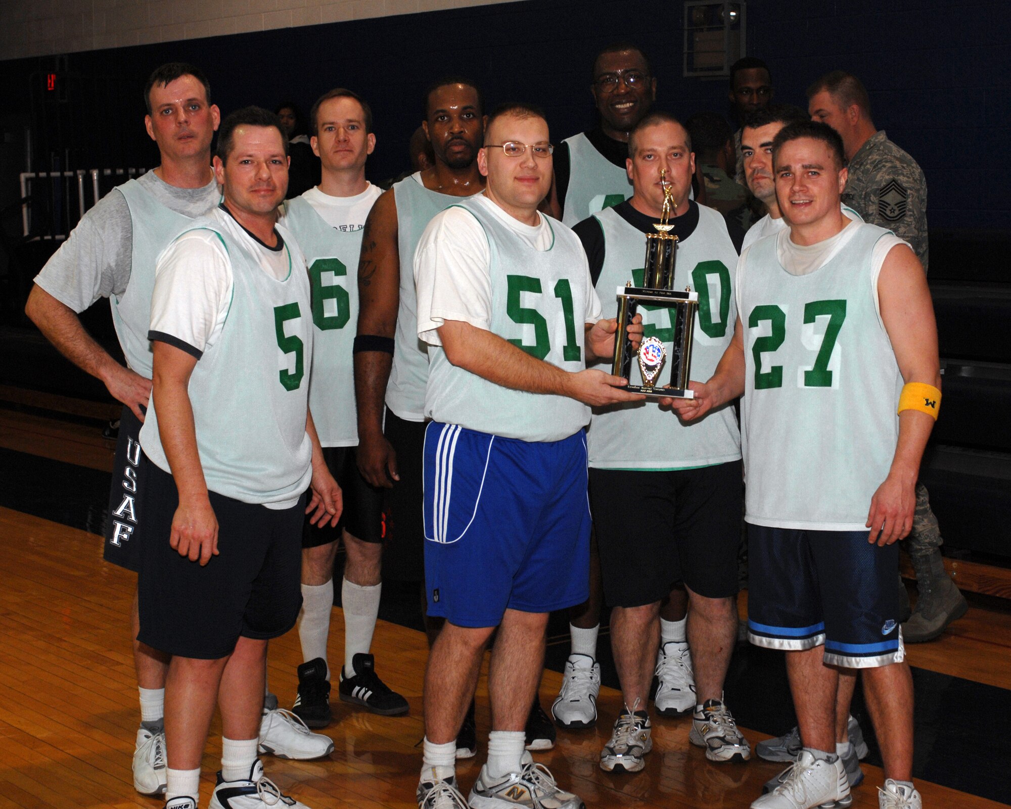 WHITEMAN AIR FORCE BASE, Mo. – 509th Communication Squadron over 30 basketball team accept their 1st place trophy Feb. 5. They pulled ahead in the last 5 minutes of the game to win 44 to 41. (U.S. Air Force photo/Tech. Sgt. Samuel A. Park) 