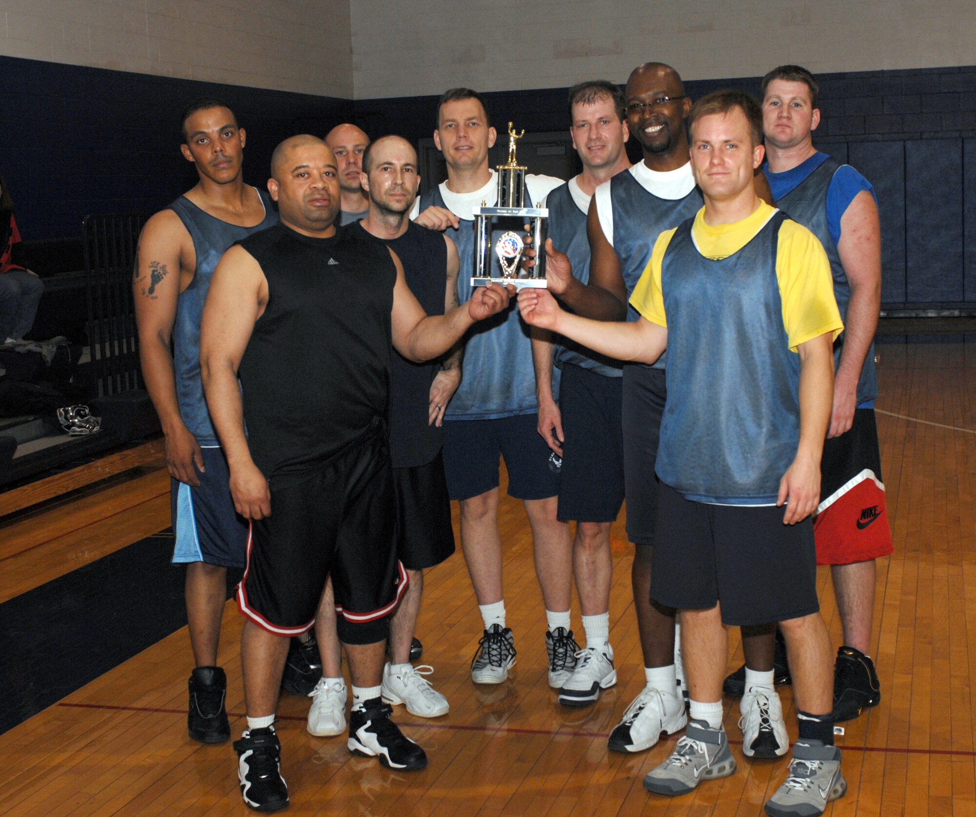 WHITEMAN AIR FORCE BASE, Mo. – 509th Services and 509th Civil Engineer Squadrons over 30 basketball team accepts their 2nd place trophy Feb.5. (U.S. Air Force photo/Tech. Sgt. Samuel A. Park) 